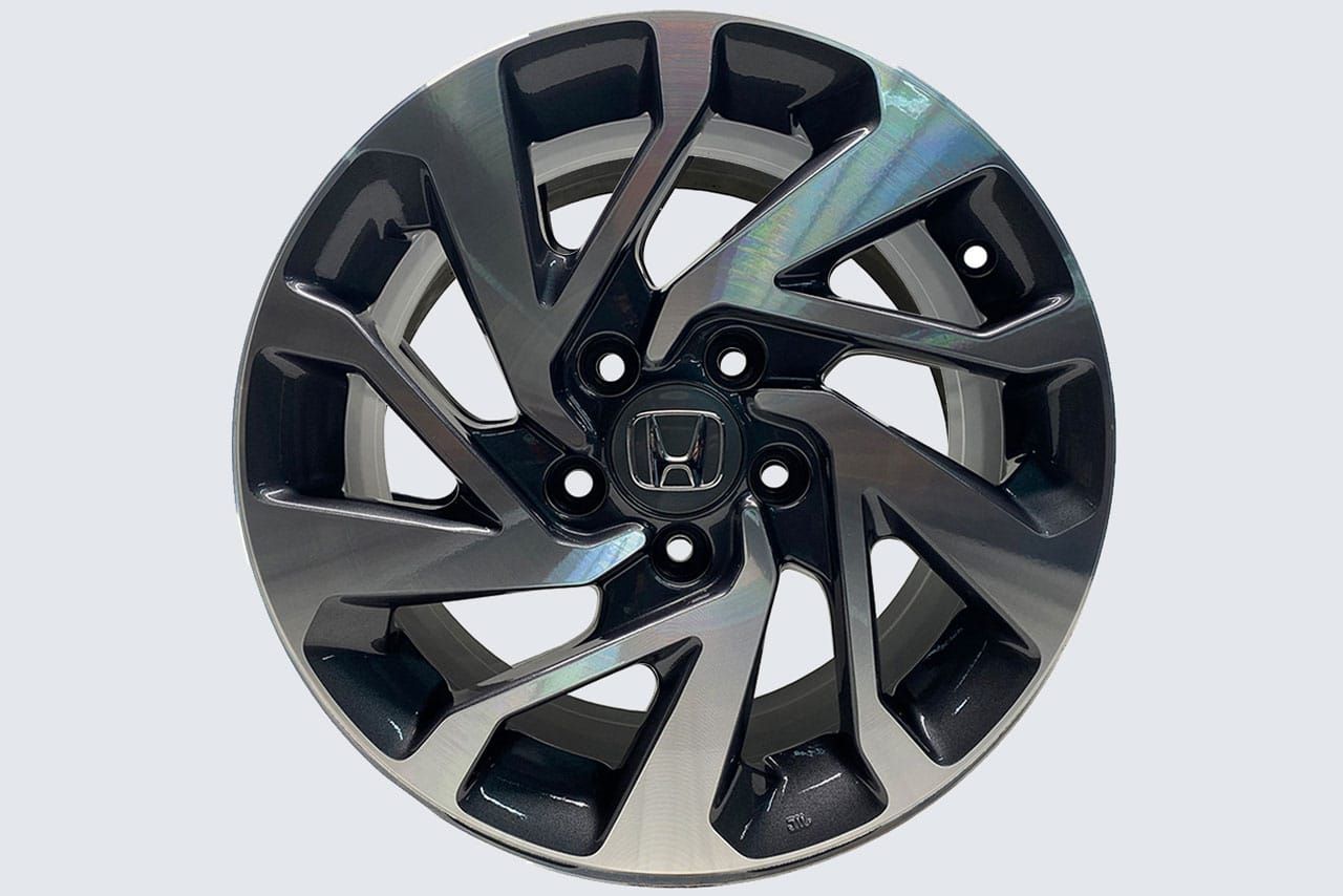 A close up of a honda wheel on a white background