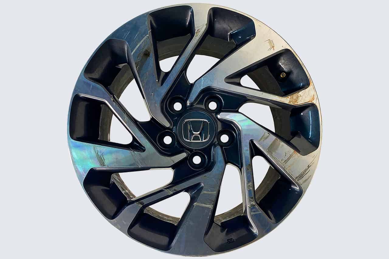 A close up of a honda wheel on a white background.