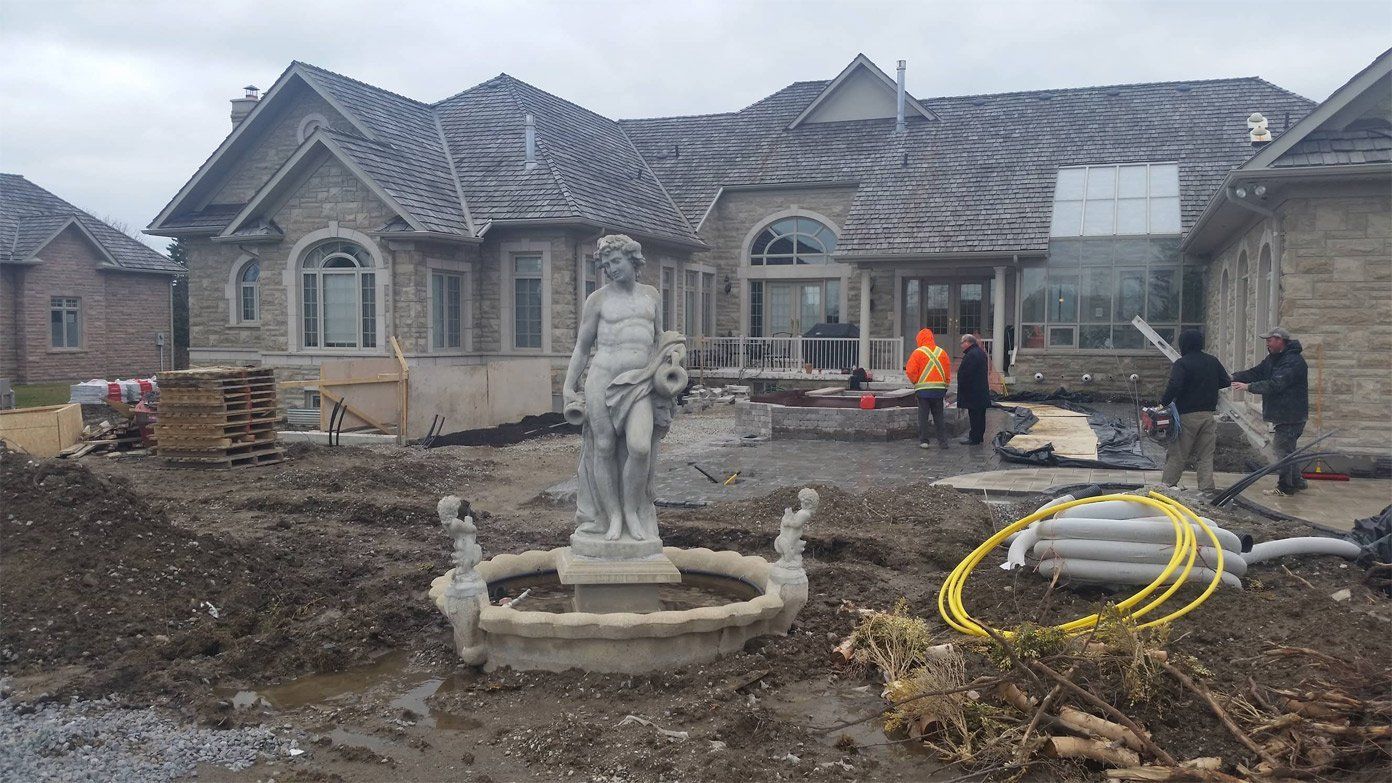 Statue in Front of a House