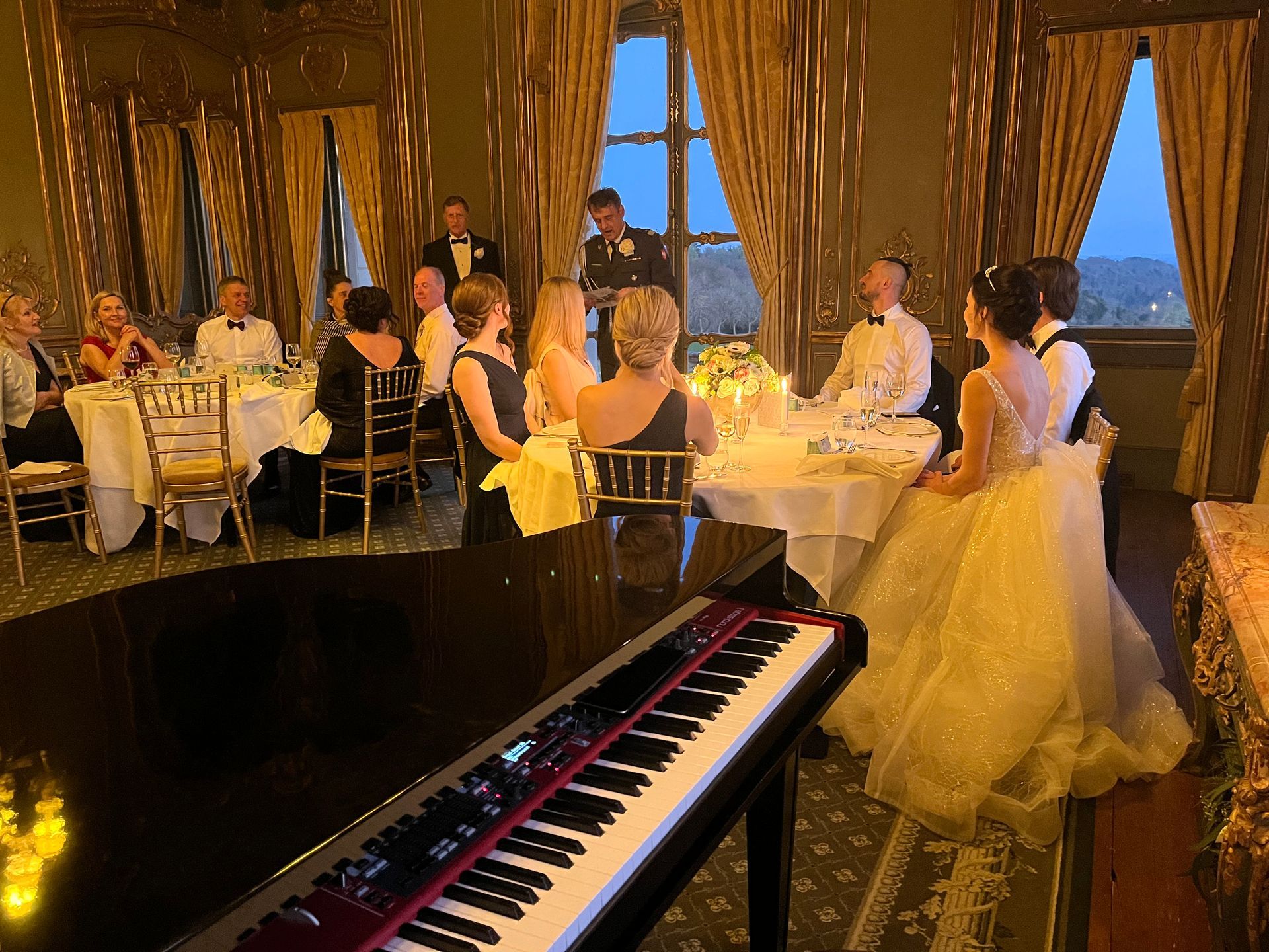 A bride and groom are kissing on the dance floor at their wedding reception.