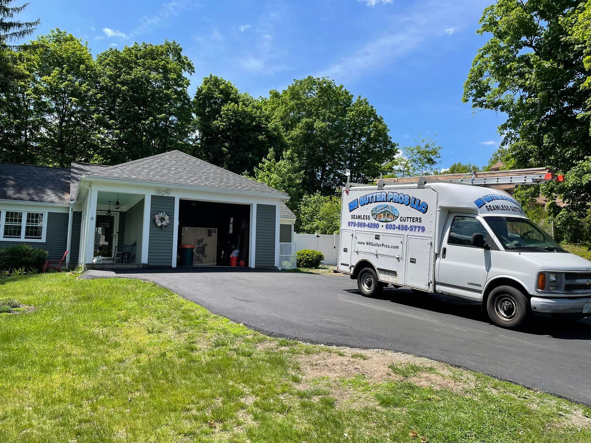 A white van is parked in front of a house.
