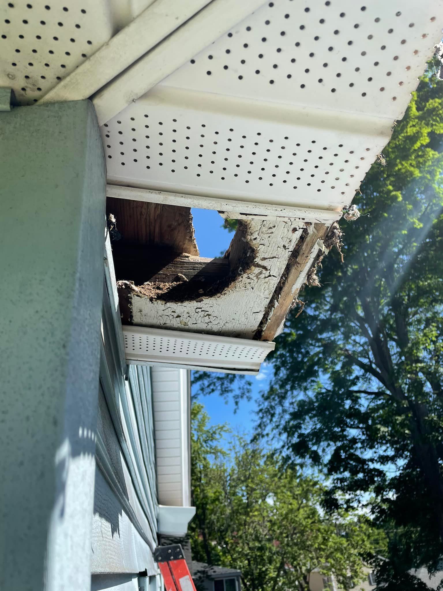 There is a hole in the roof of a house.