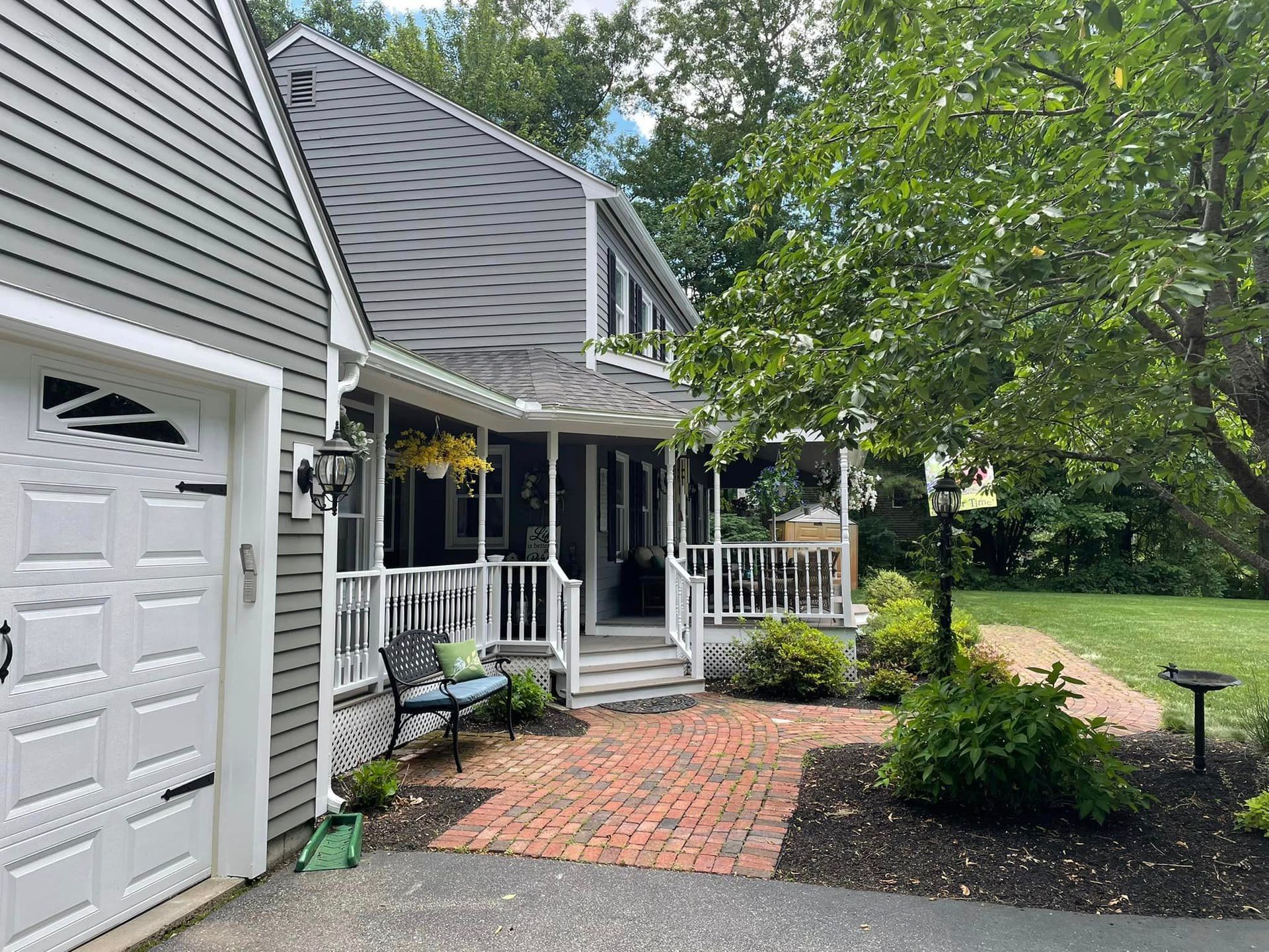 A house with a brick walkway leading to the front door and a garage.