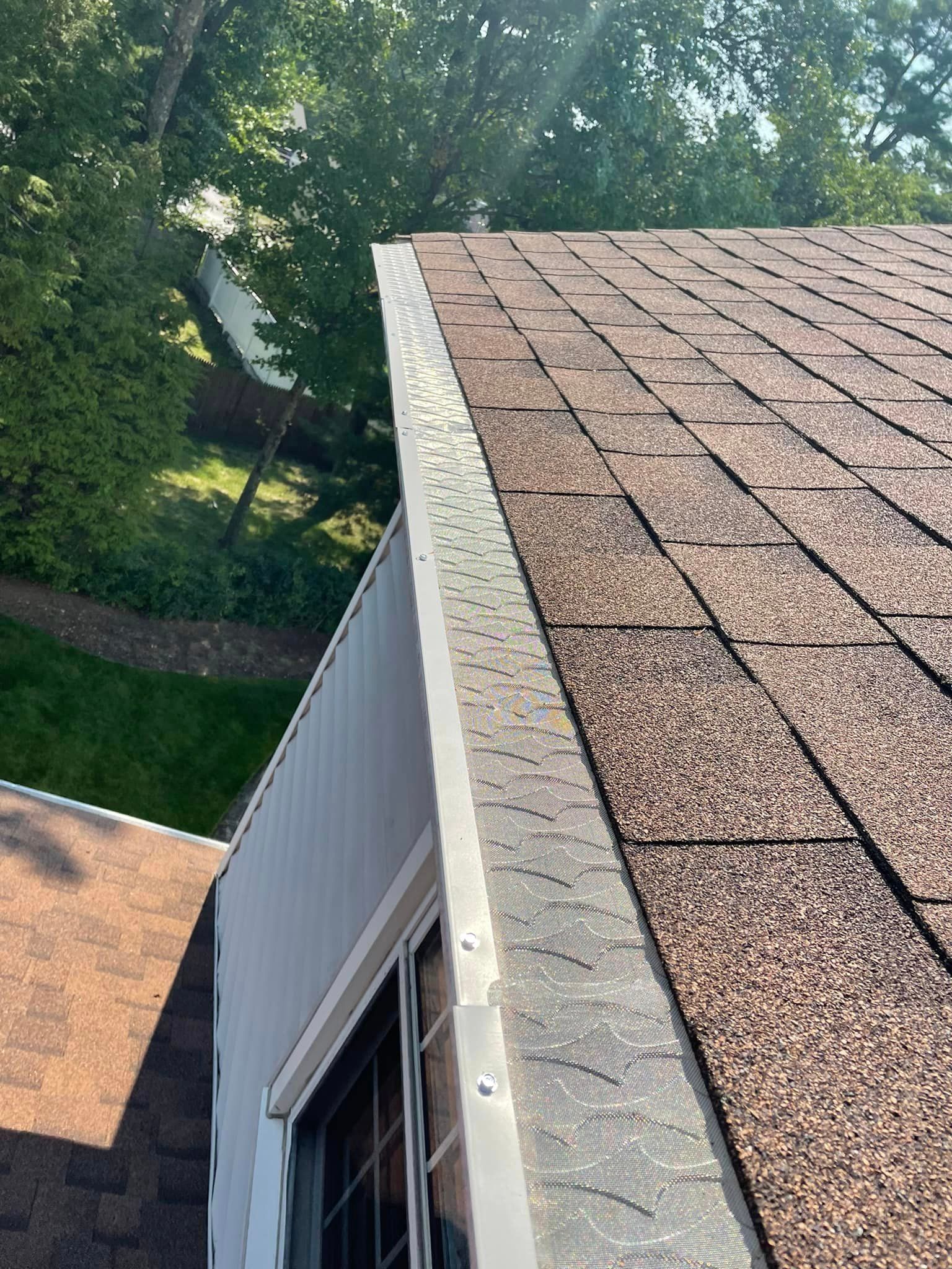 A close up of a roof with a gutter on it.