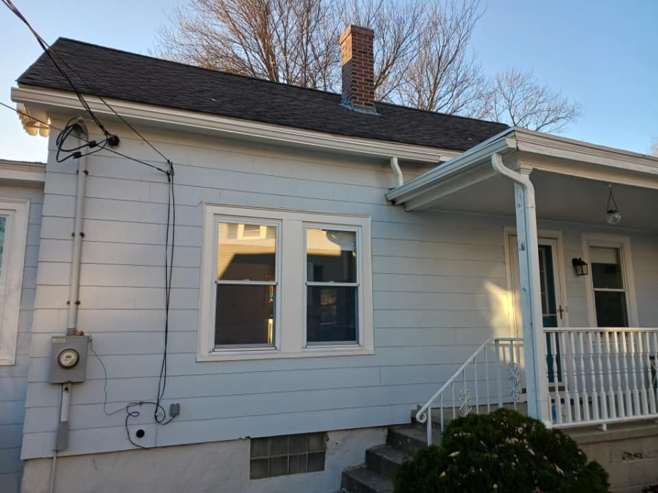 A white house with a porch and stairs