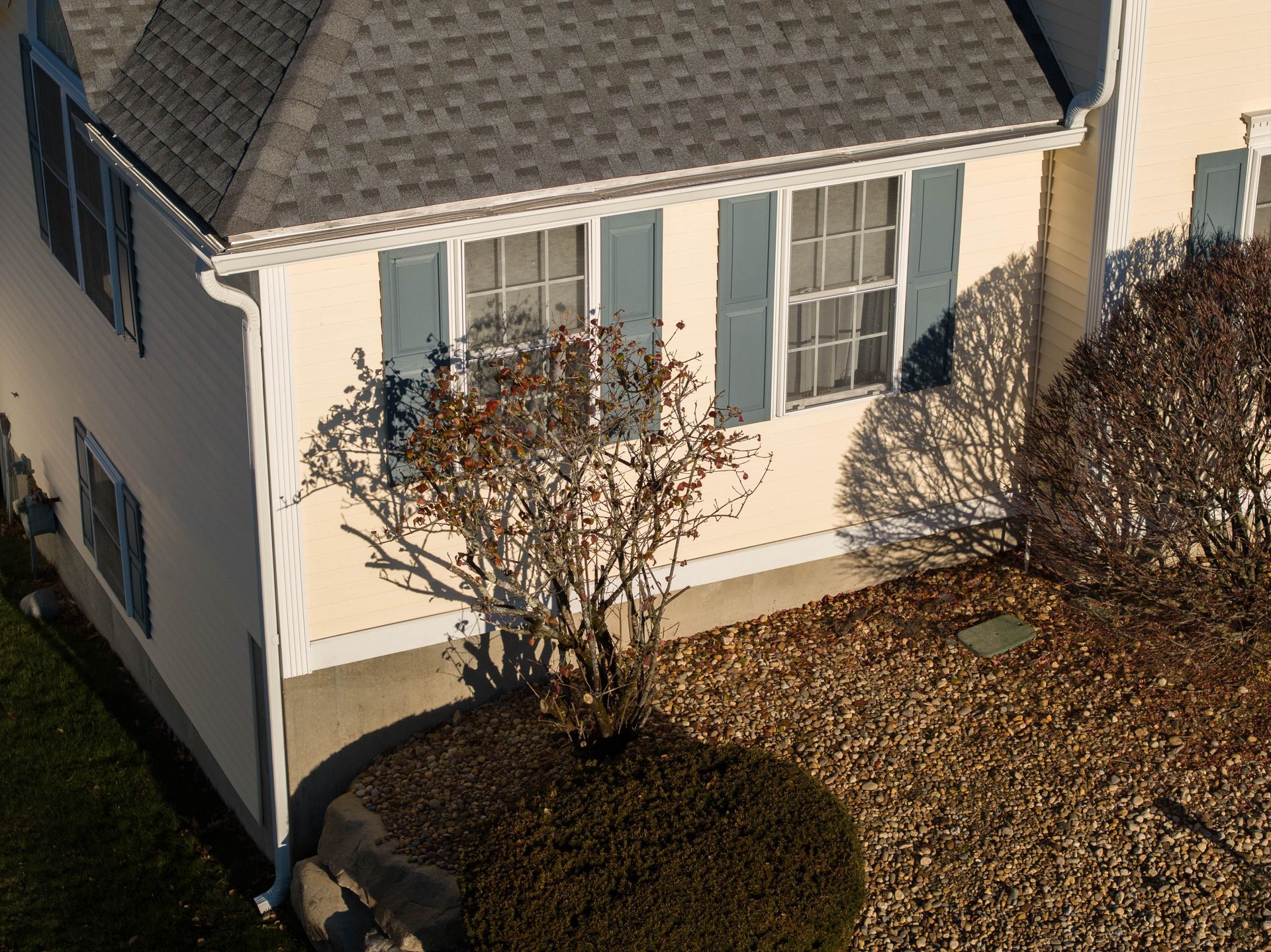 An aerial view of a house with blue shutters