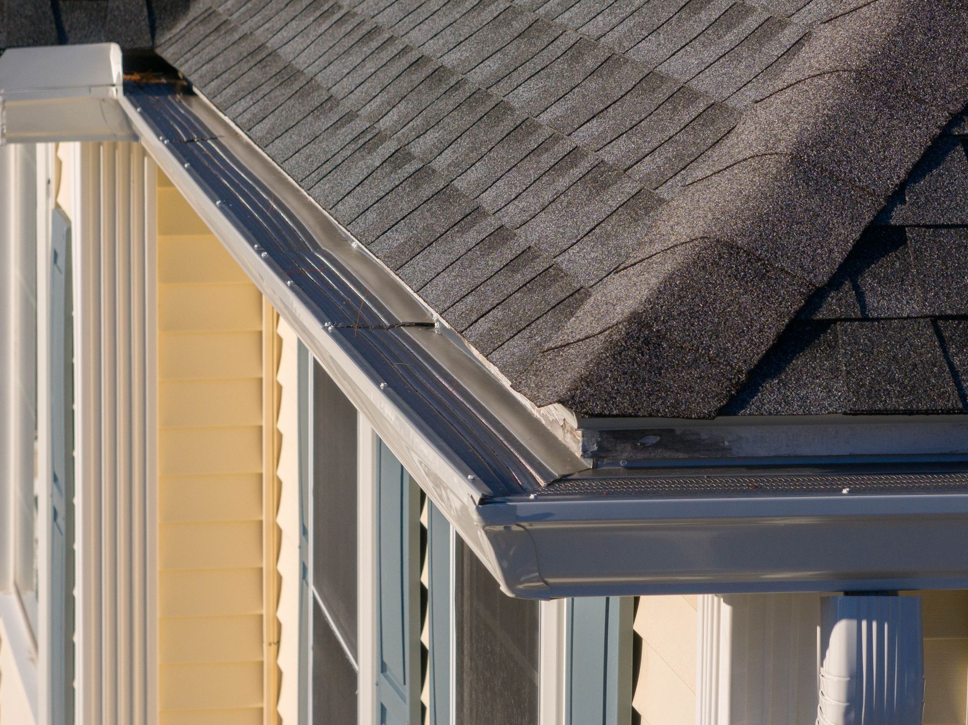 A house with a gutter on the side of it