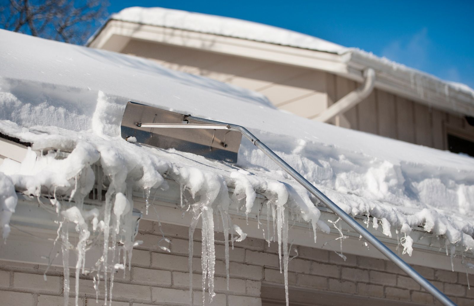 A close up of a gutter on the side of a building.