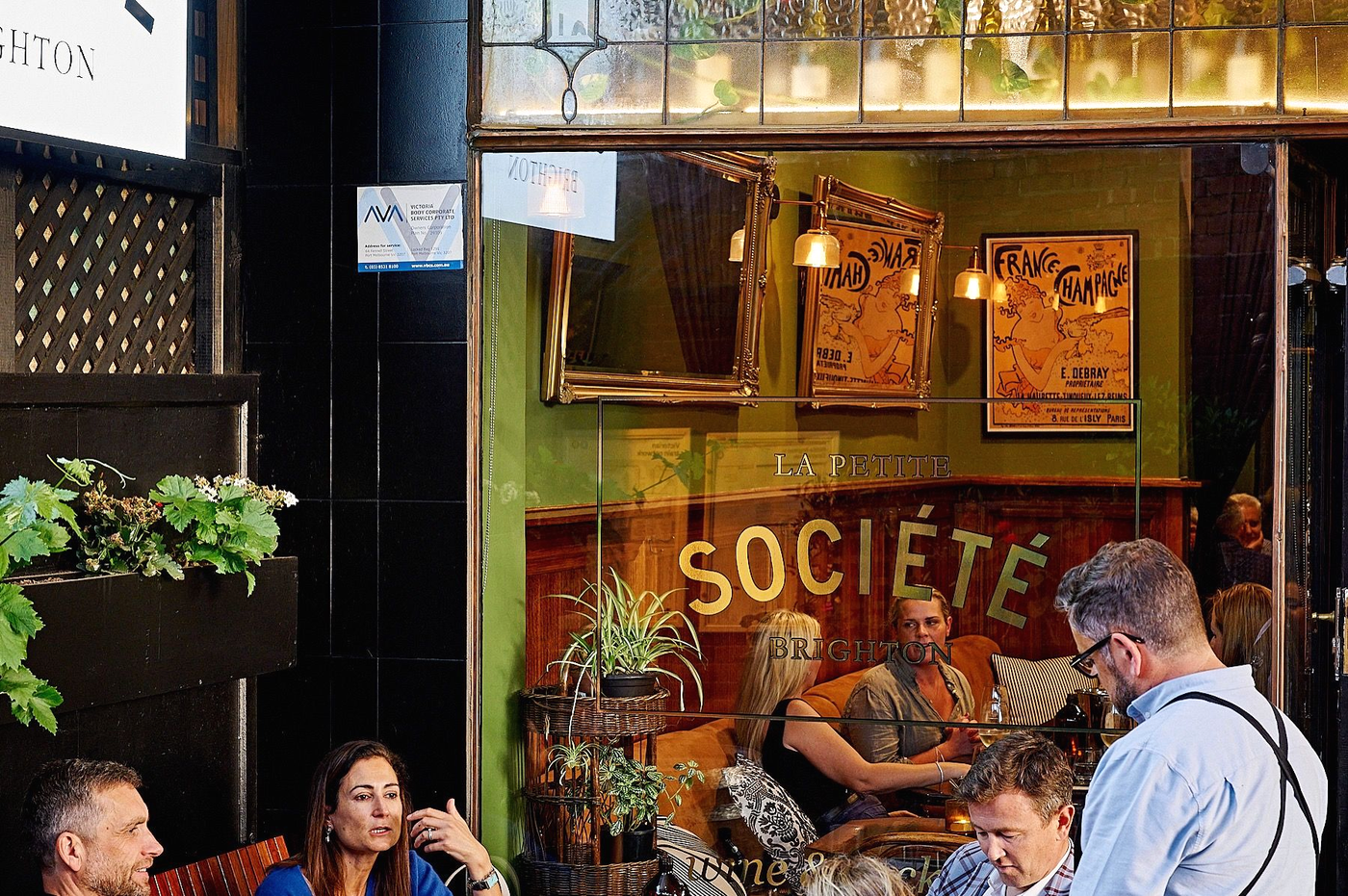People seated outside a restaurant called 