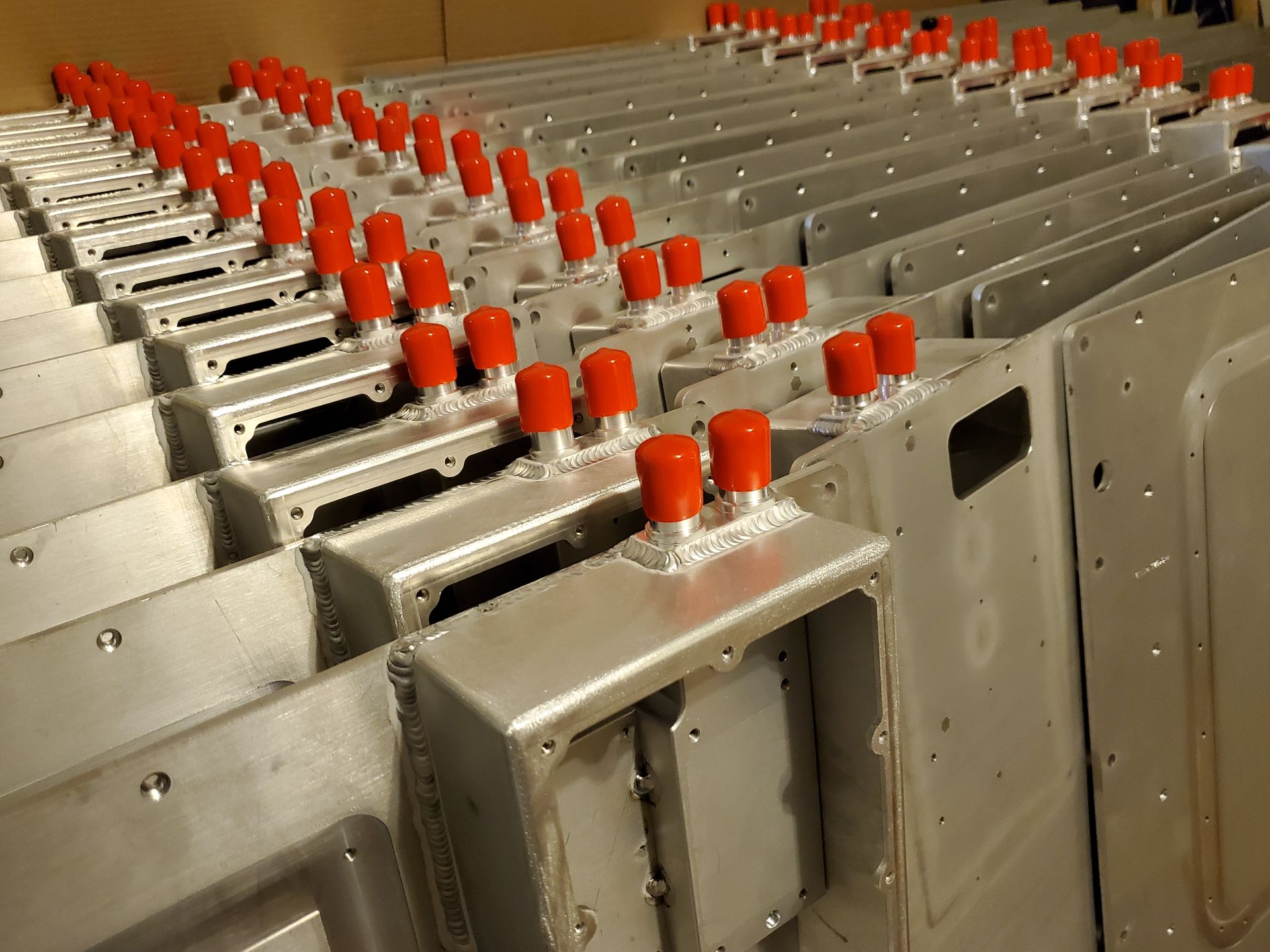 A row of metal boxes with red caps on them
