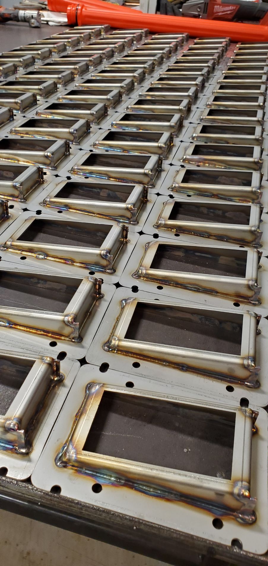 A bunch of metal frames are sitting on top of each other on a table.