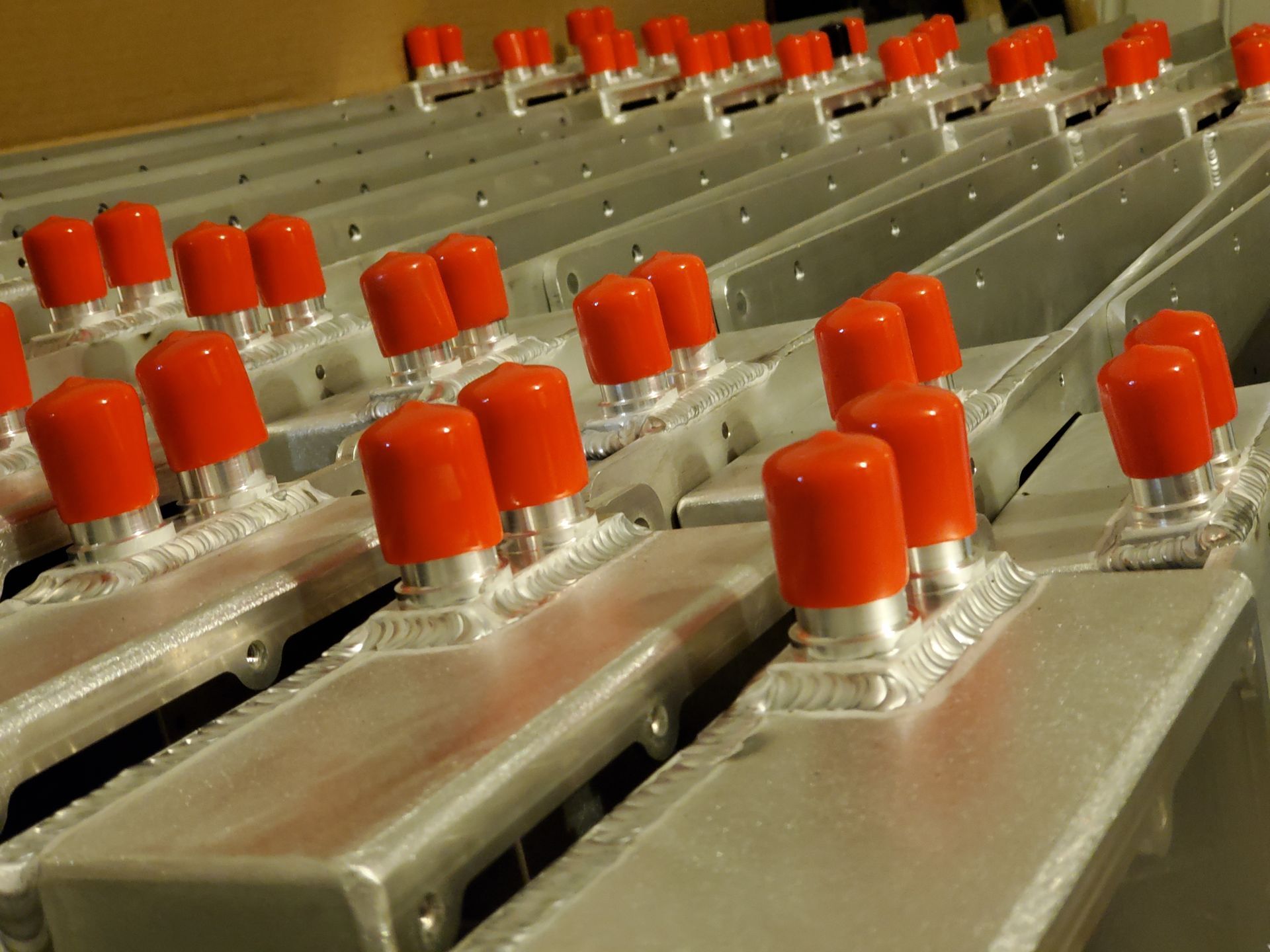 A bunch of metal pieces with red caps on them