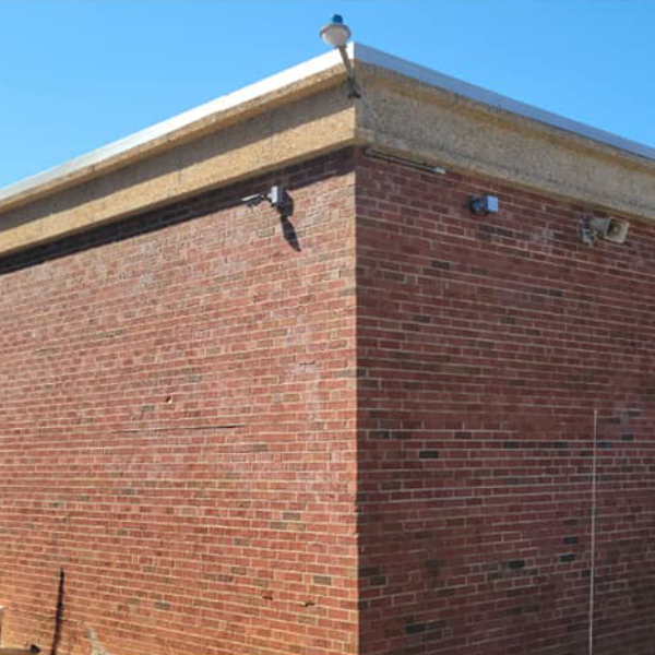 a brick building with a bird on top of it