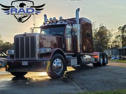 A large semi truck is parked on the side of the road.