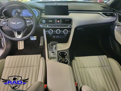 The interior of a car with a steering wheel and a dashboard.