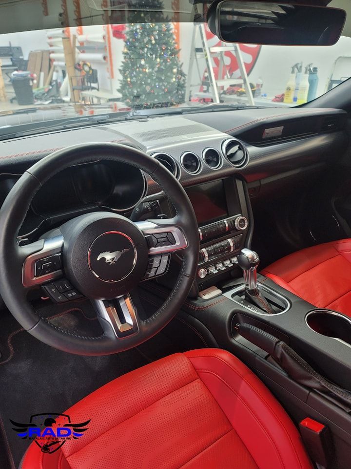 The interior of a ford mustang with red seats