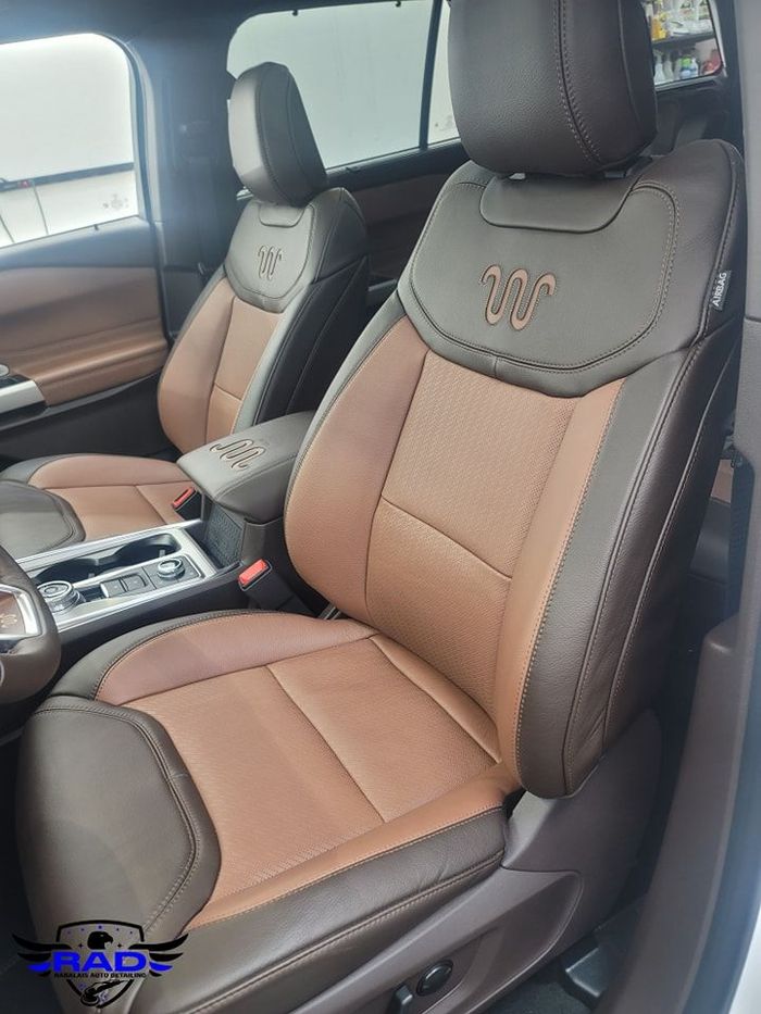 The seats of a ford explorer are brown and black.