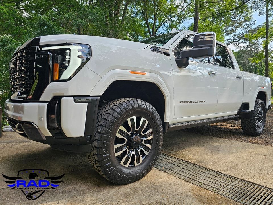 A white truck is parked on the side of the road.