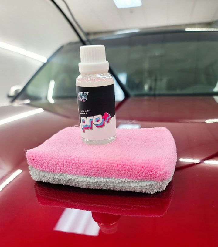 A bottle of pro sitting on top of a pink towel