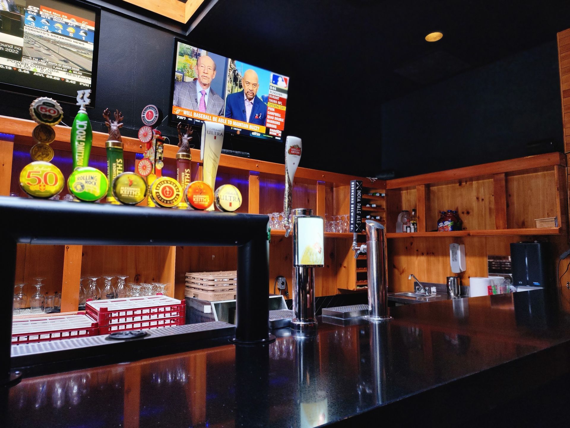 A bar with a tv on the wall that says fox news