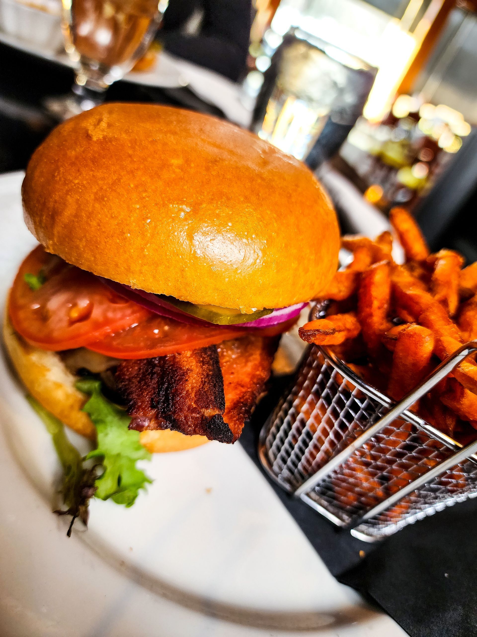 A hamburger and french fries on a white plate