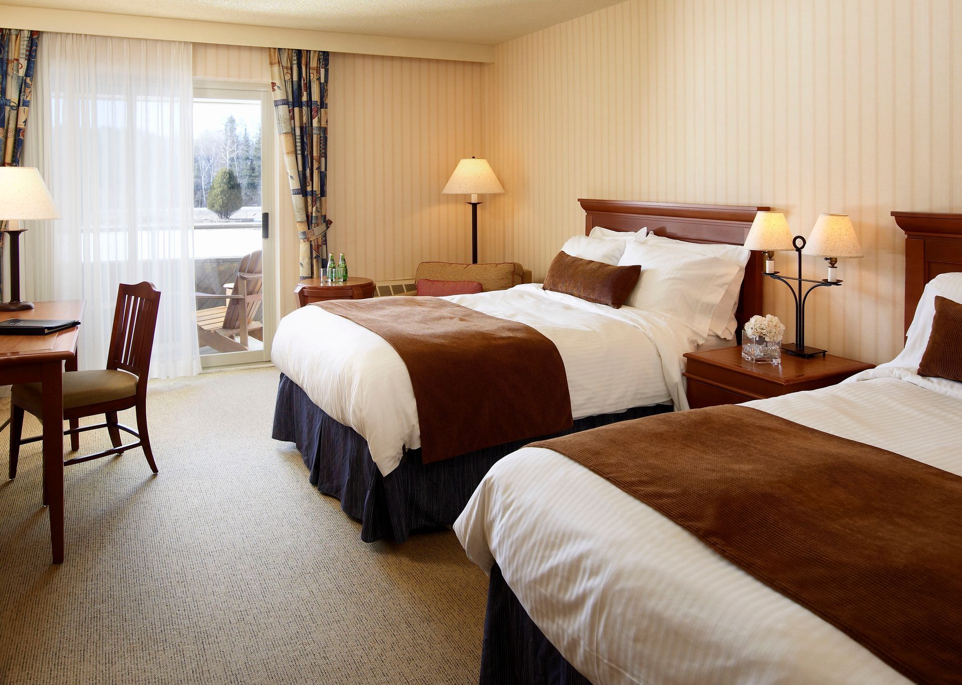 A hotel room with two beds and a desk
