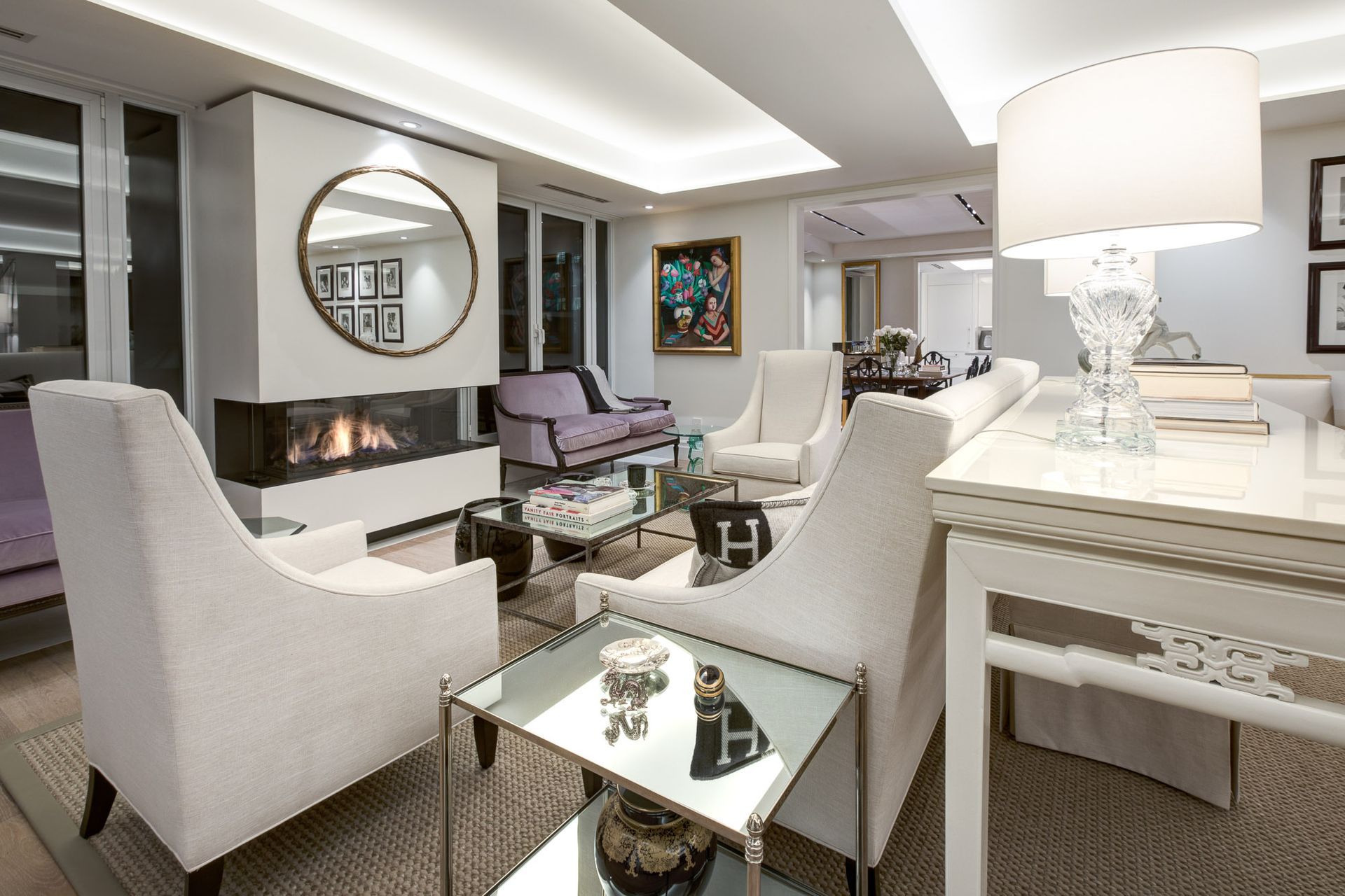 A living room with white furniture and a fireplace