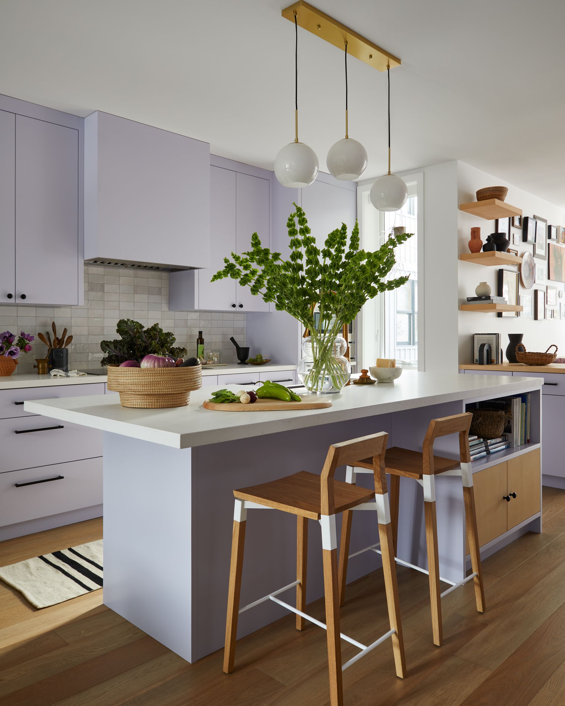 A kitchen with purple cabinets and a large island