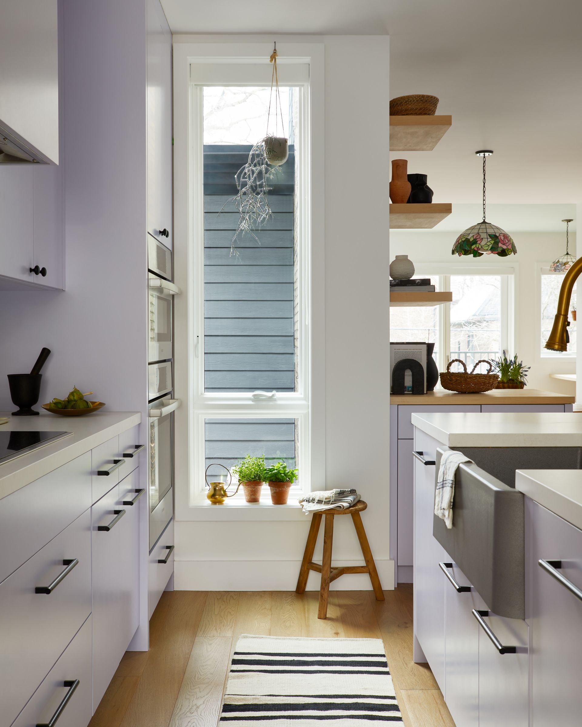 A kitchen with purple cabinets and a large island