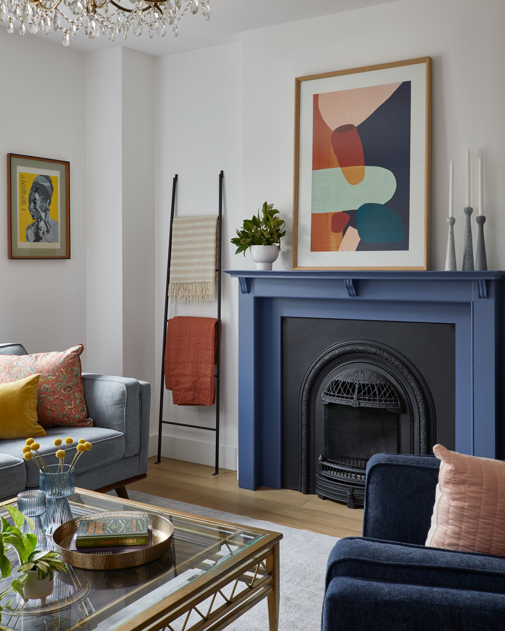 A living room with a blue fireplace and a blue couch