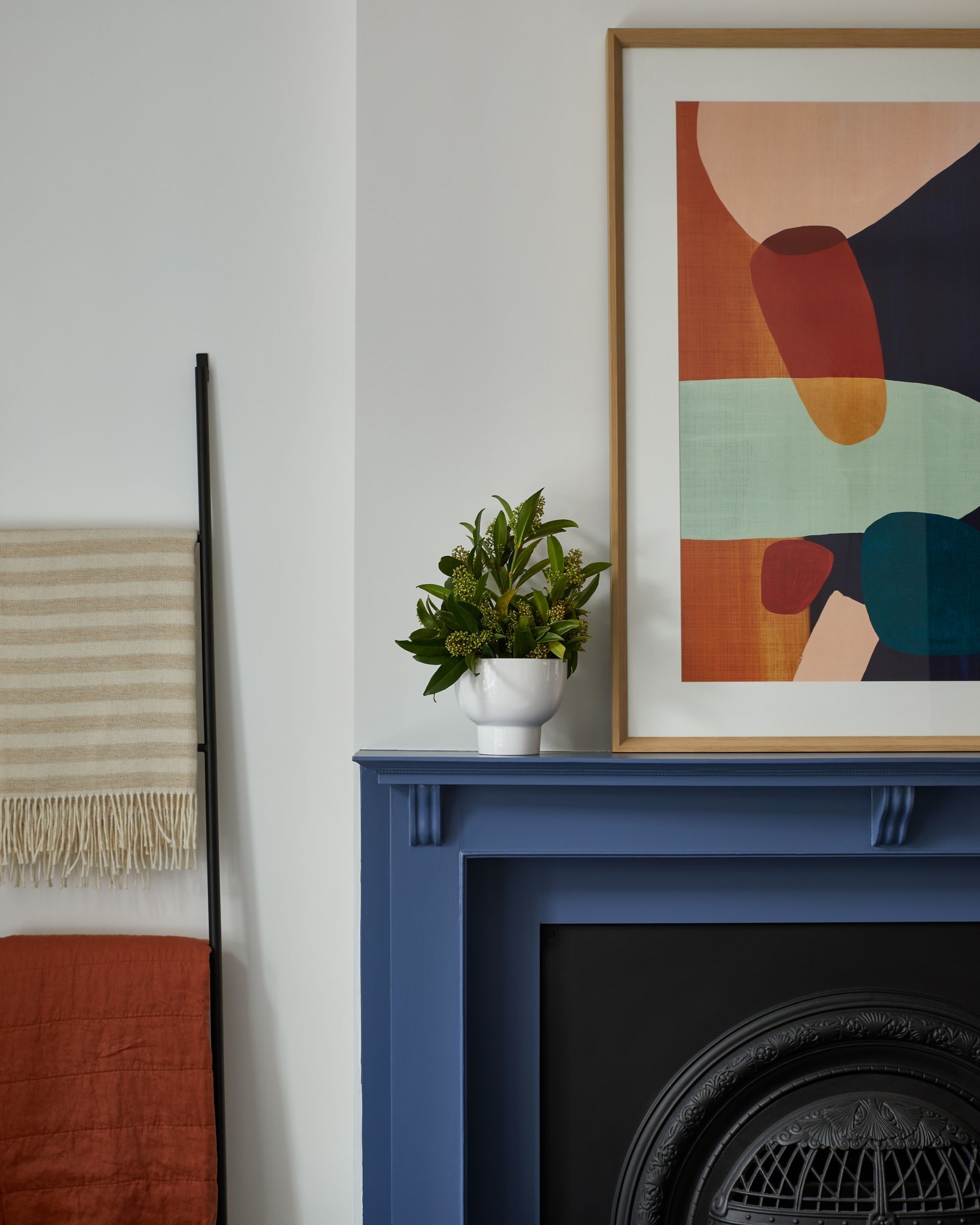 A fireplace with a framed picture on top of it