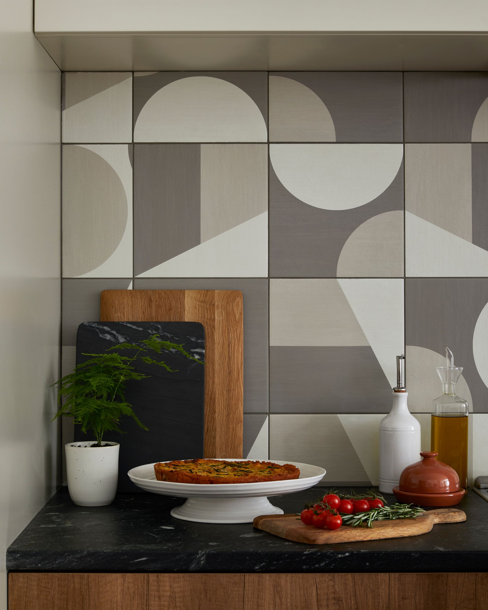 A kitchen counter with a cutting board and a plate of food on it.