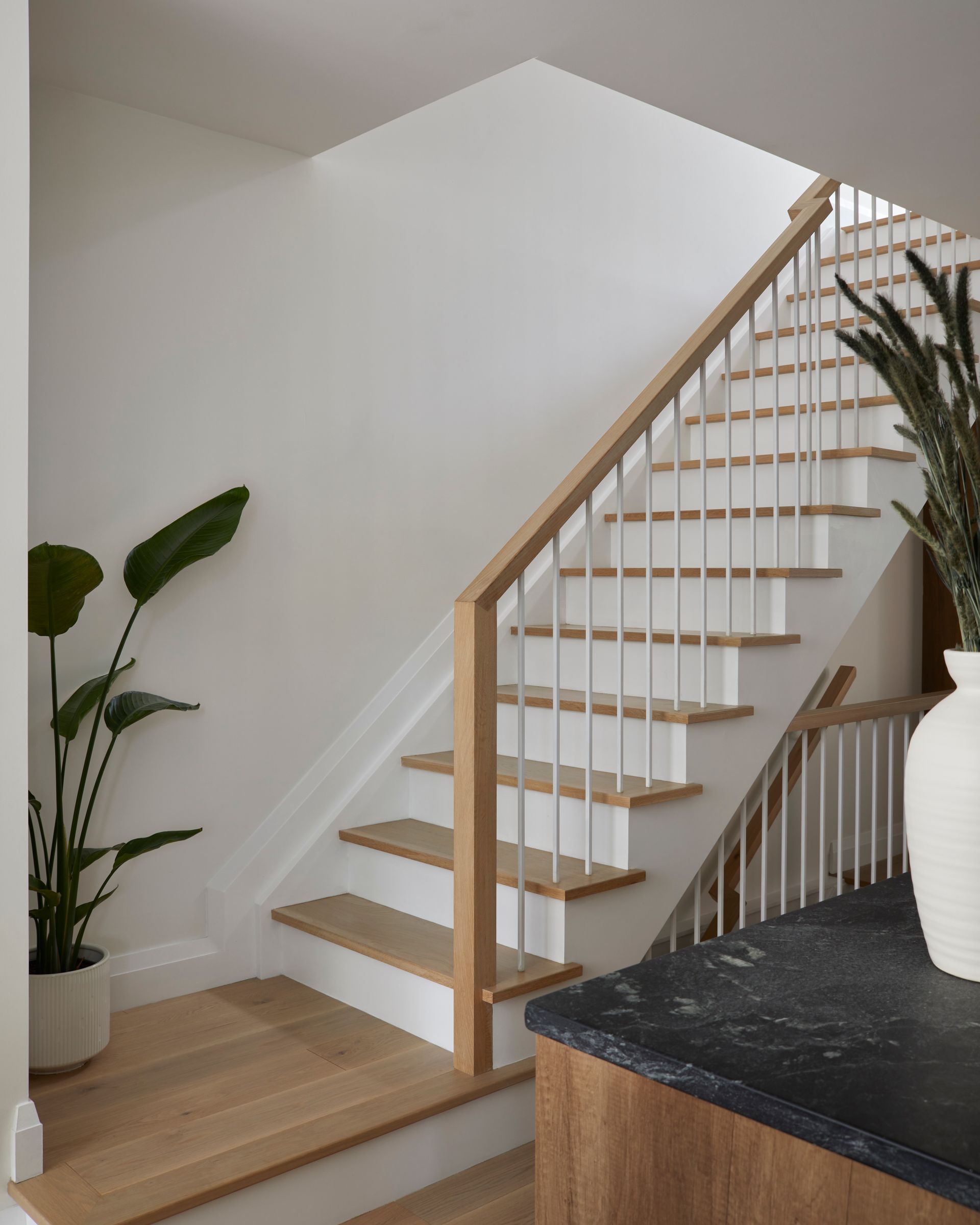 A staircase with a wooden railing in a house