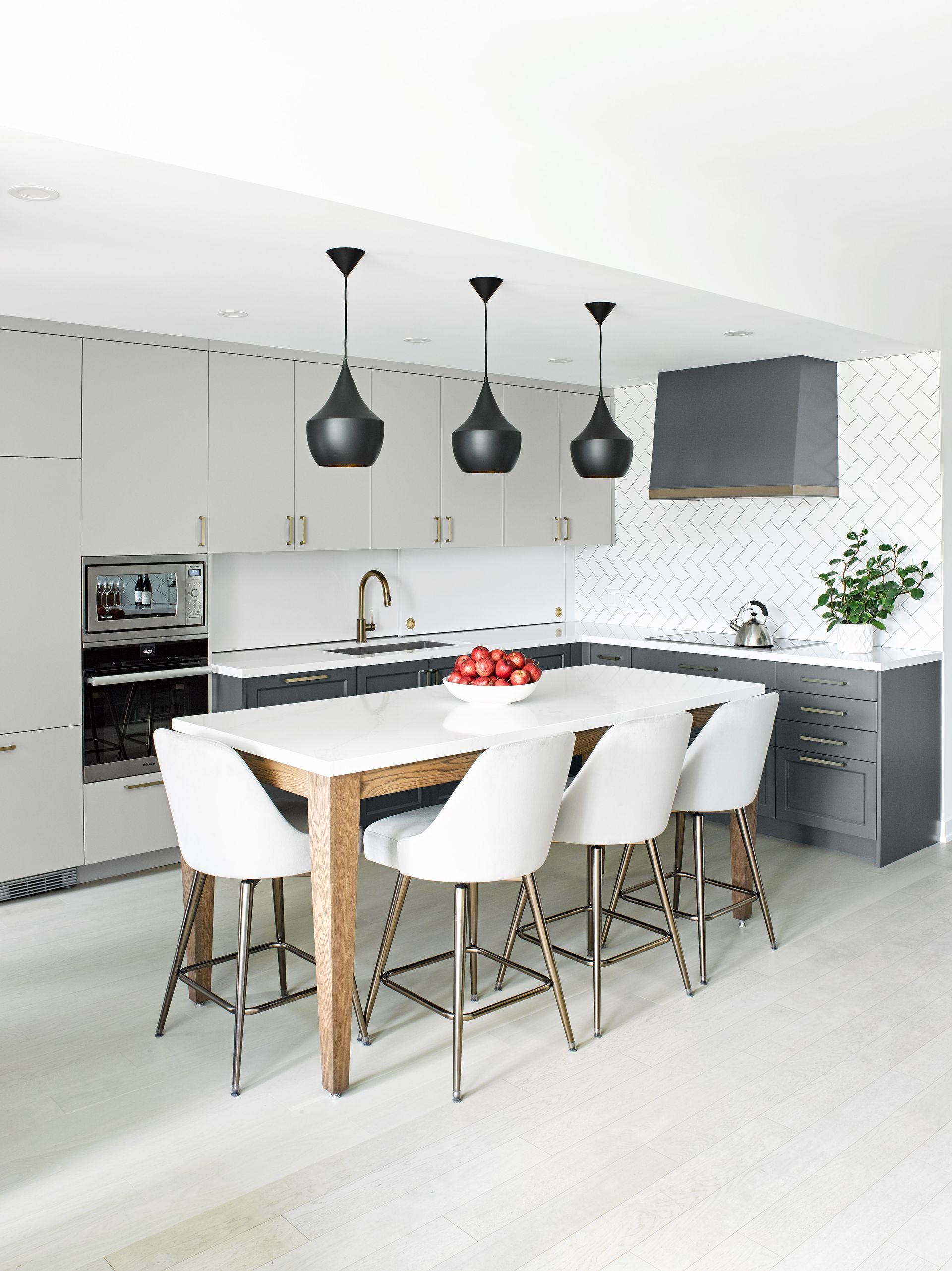 A kitchen with a table and chairs in it