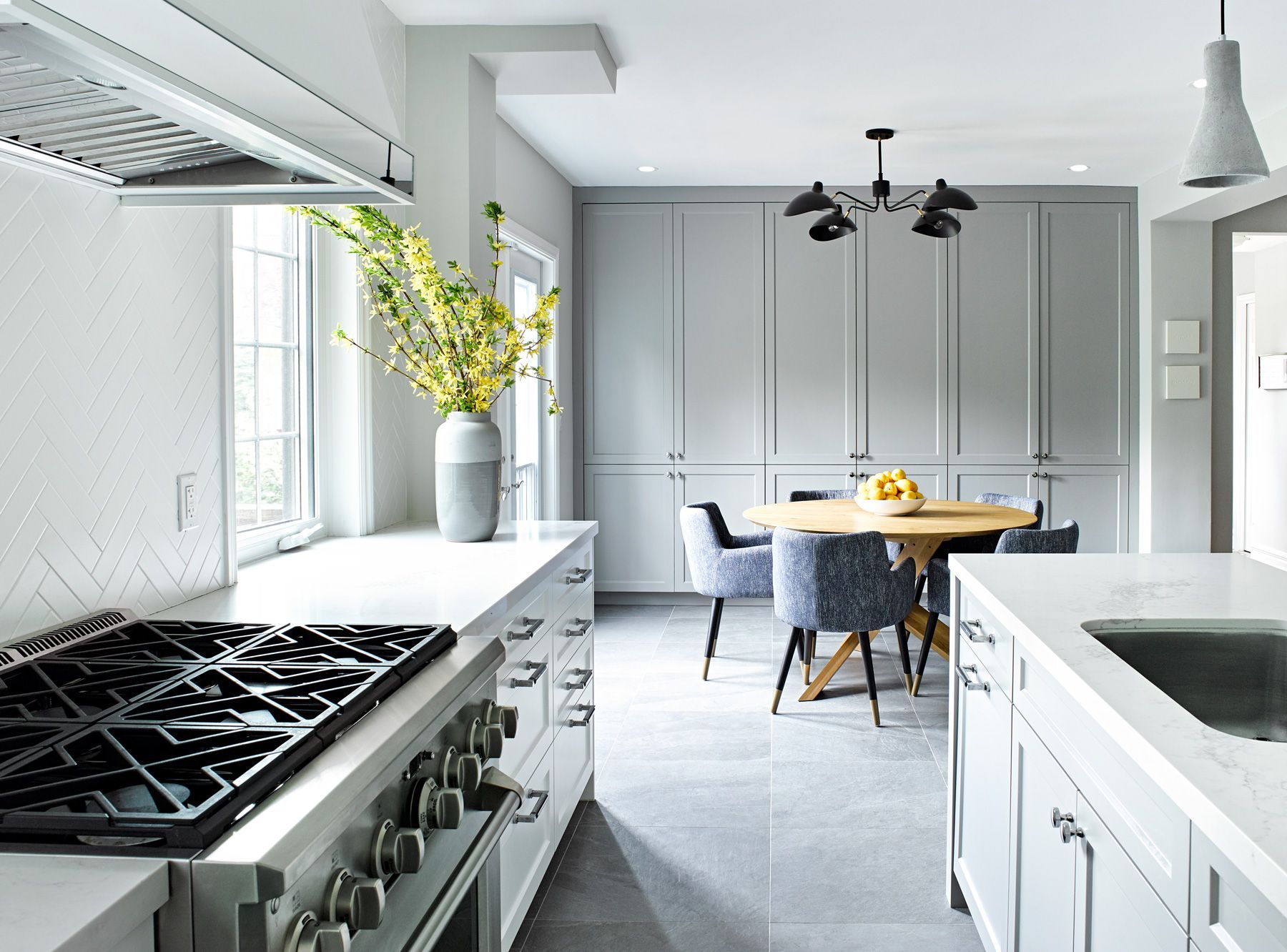 A kitchen with a stove top oven and a sink