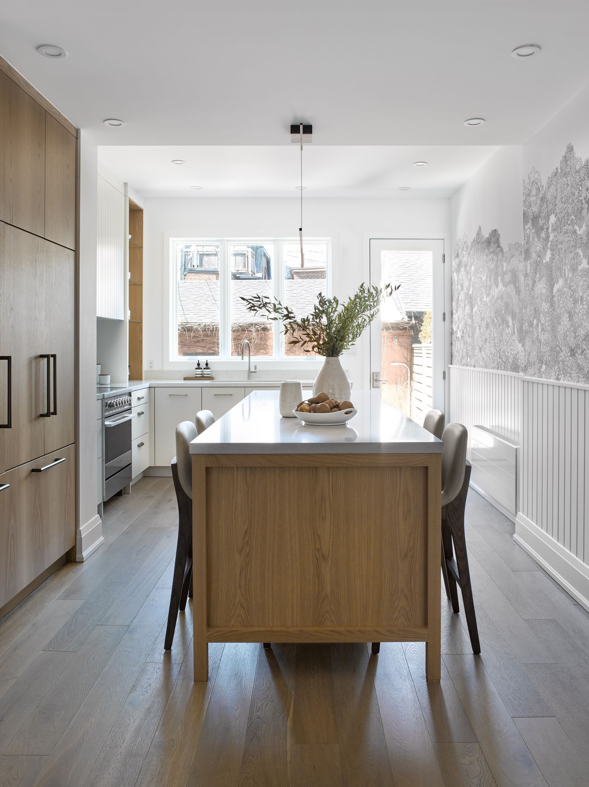 A kitchen with a large wooden island in the middle