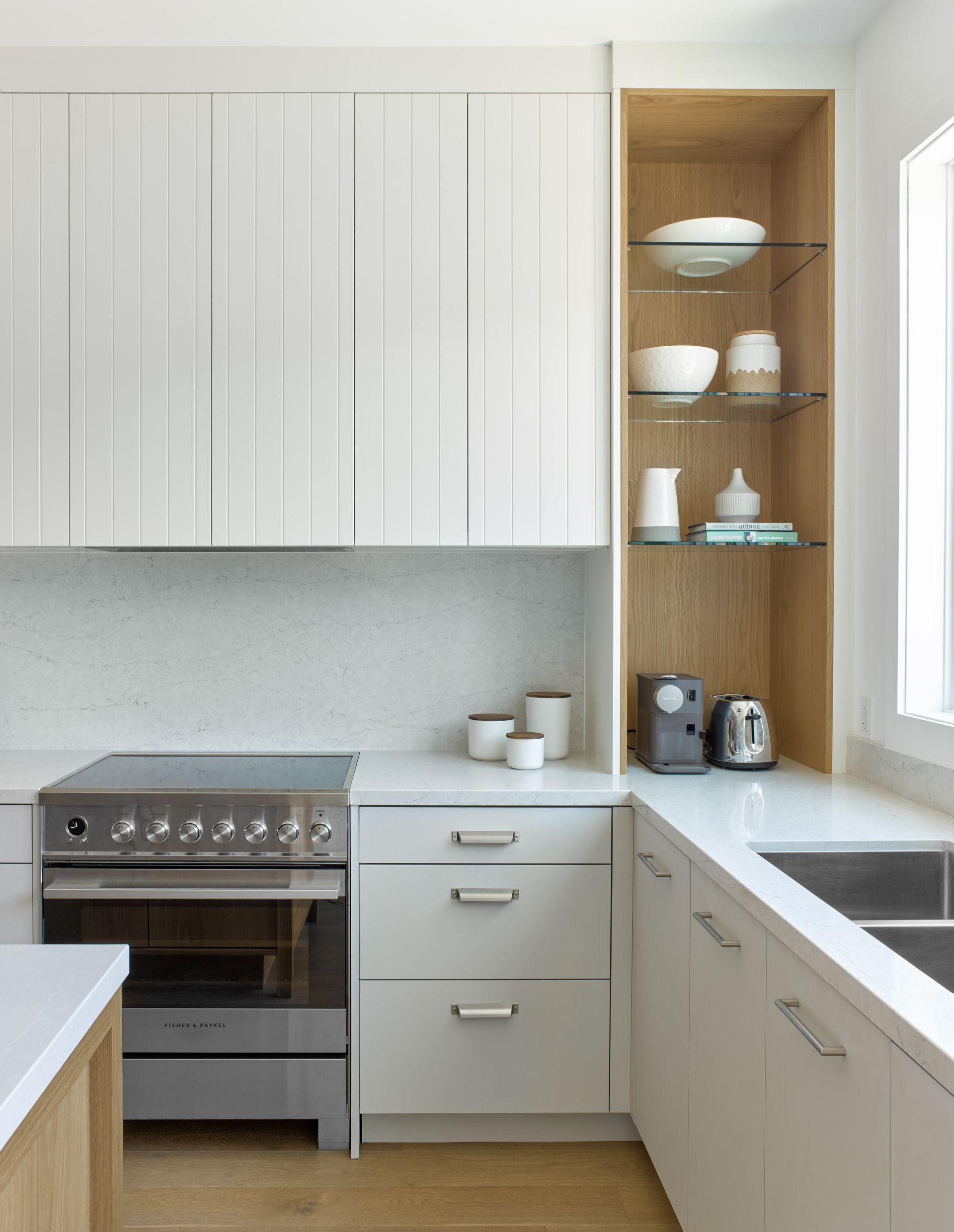 A kitchen with white cabinets and stainless steel appliances