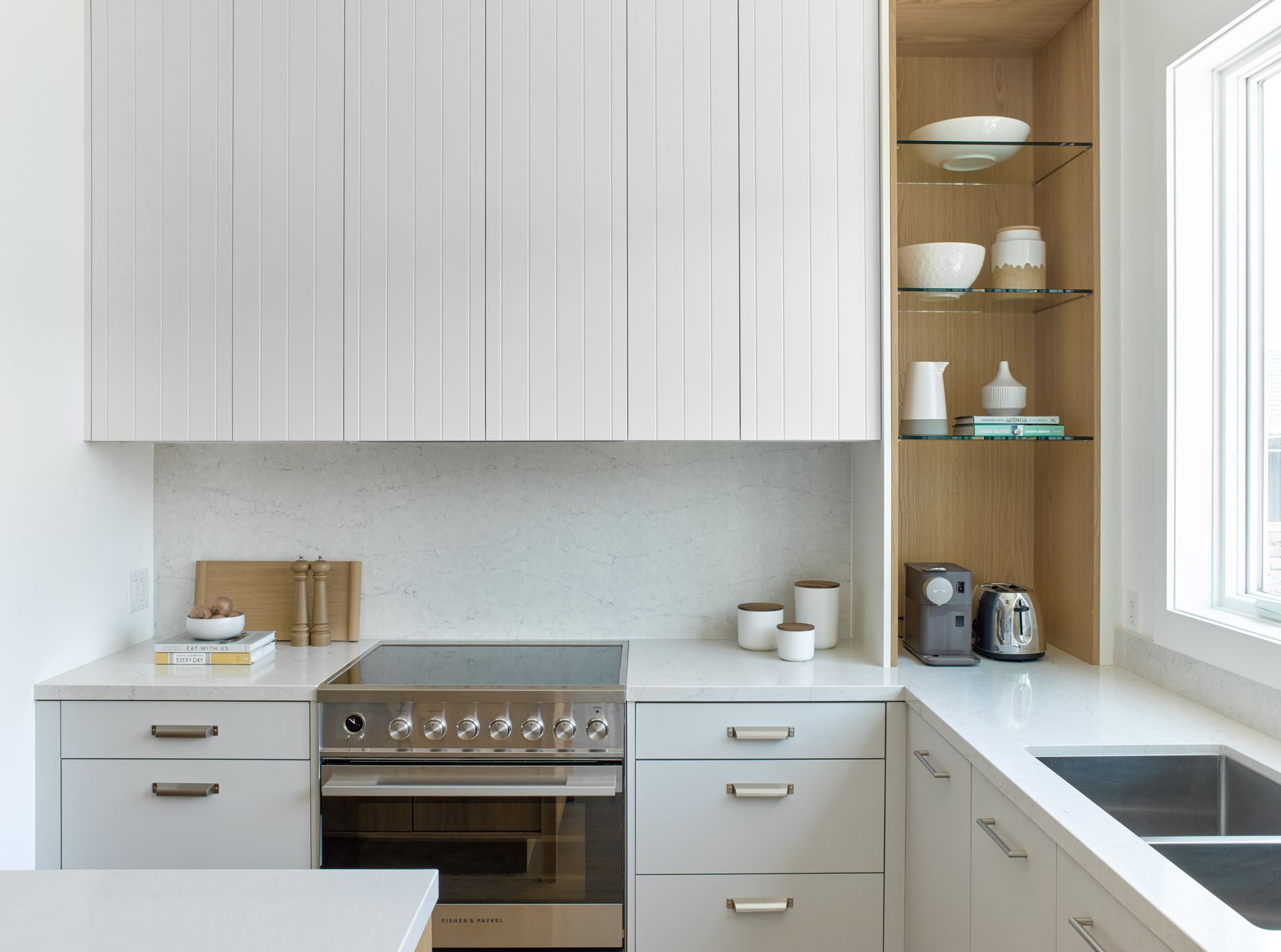 A kitchen with white cabinets and stainless steel appliances