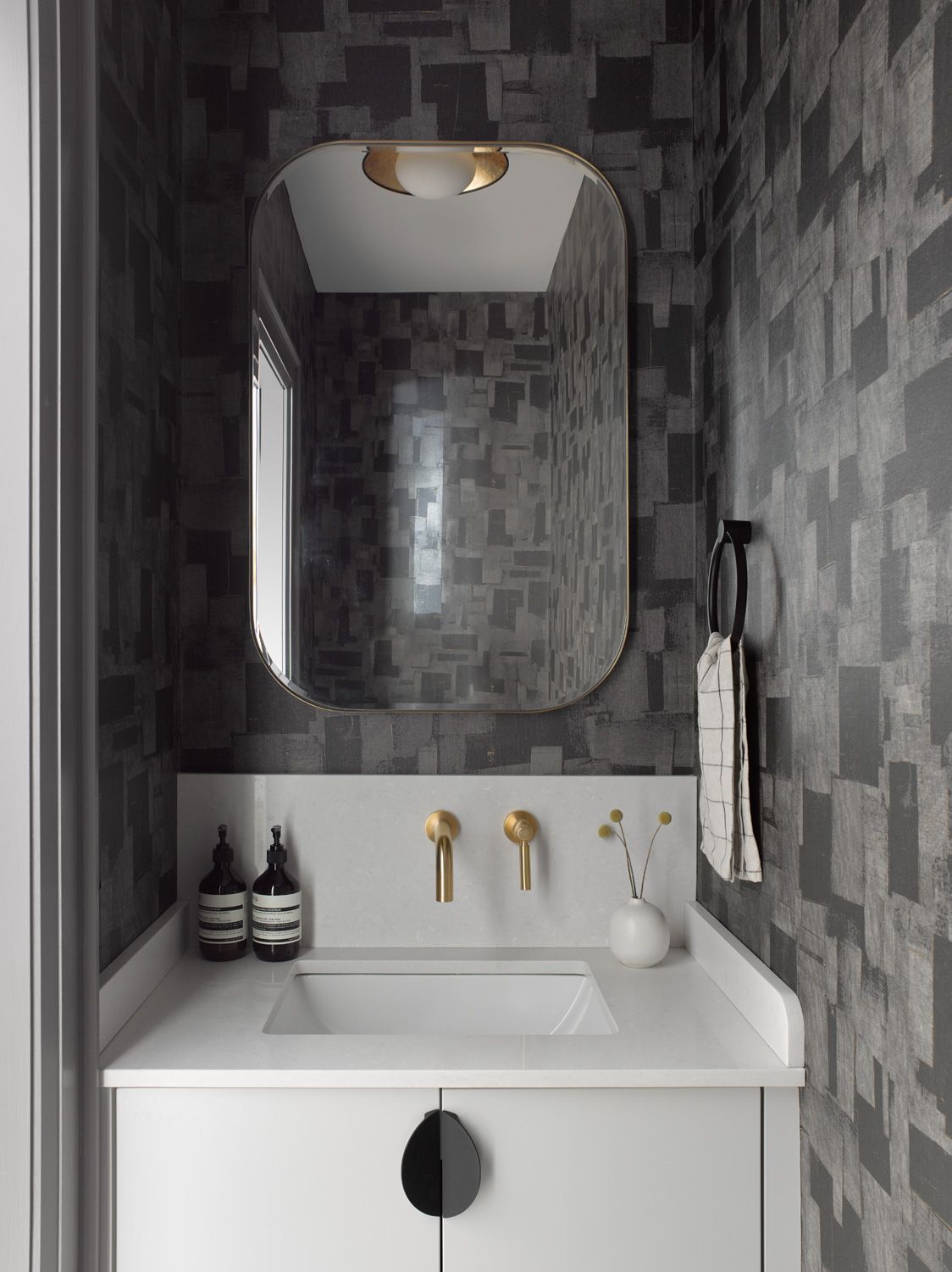 A bathroom with a sink and a mirror on the wall.