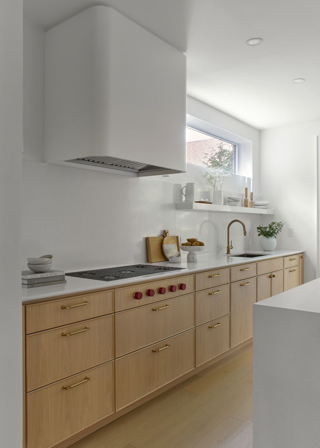 A kitchen with wooden cabinets and white counter tops.