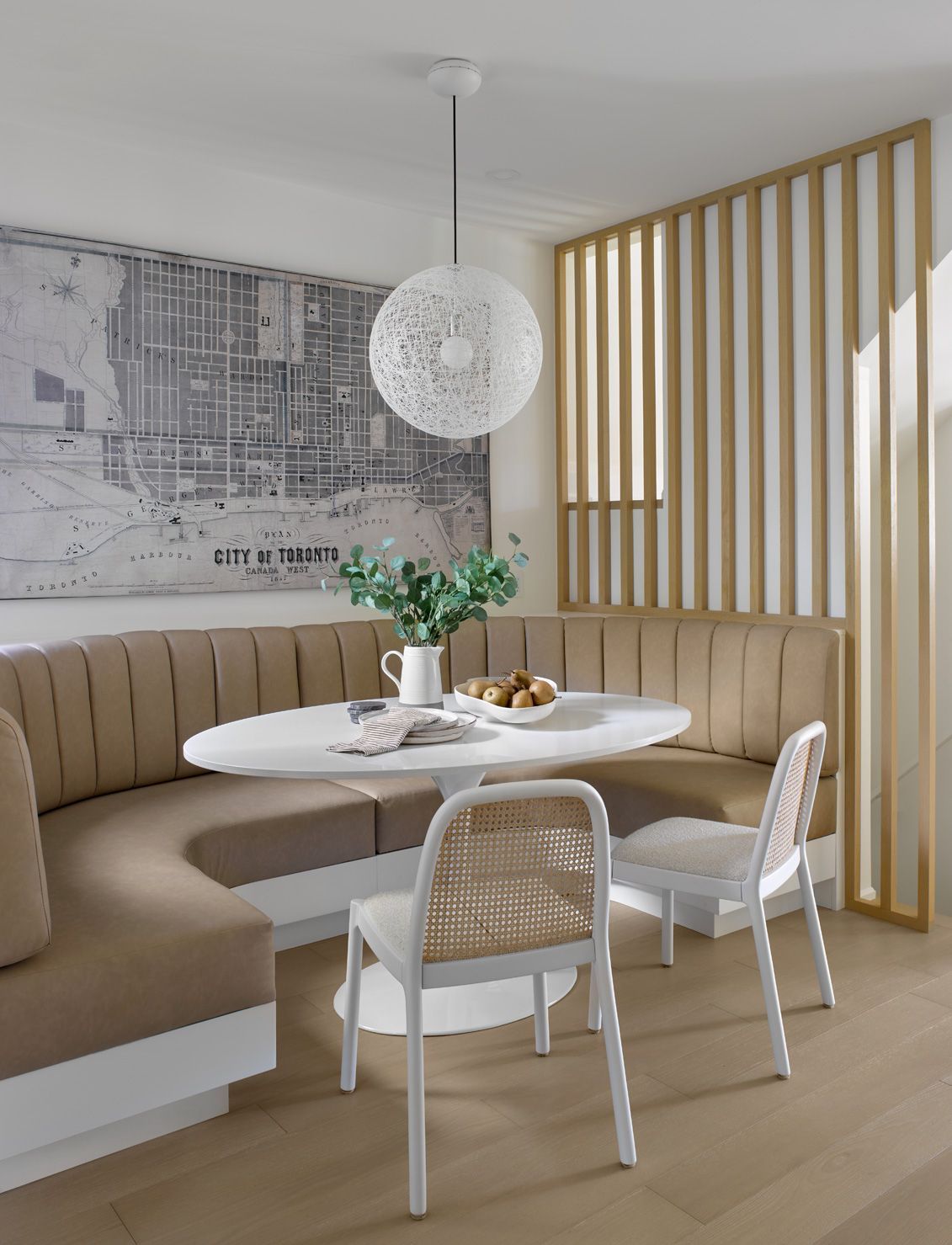 A dining room with a table and chairs and a bench