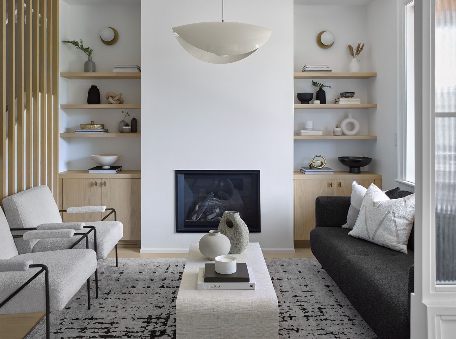 There is a fireplace in the middle of the living room.