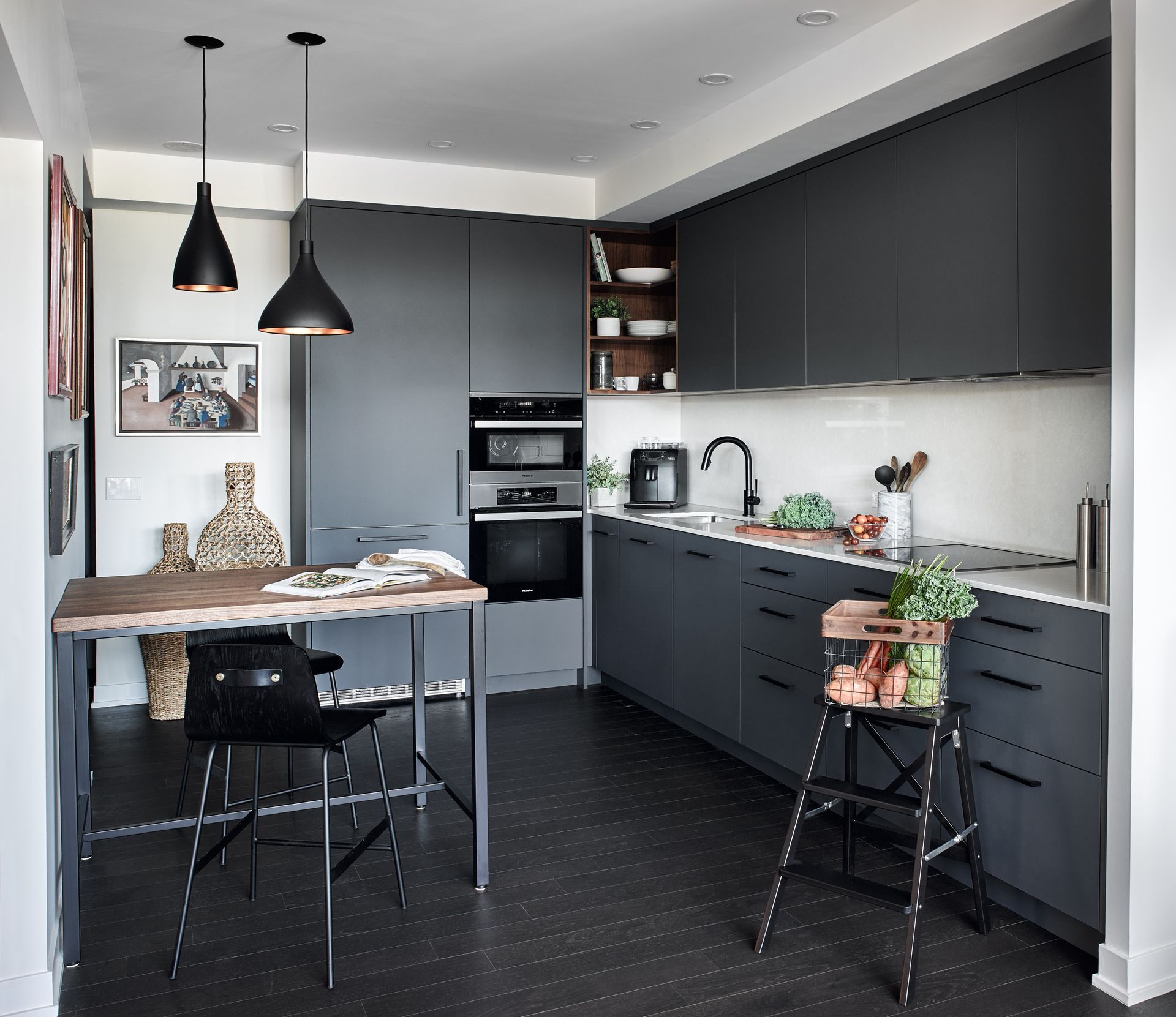 A kitchen with a table and chairs in it