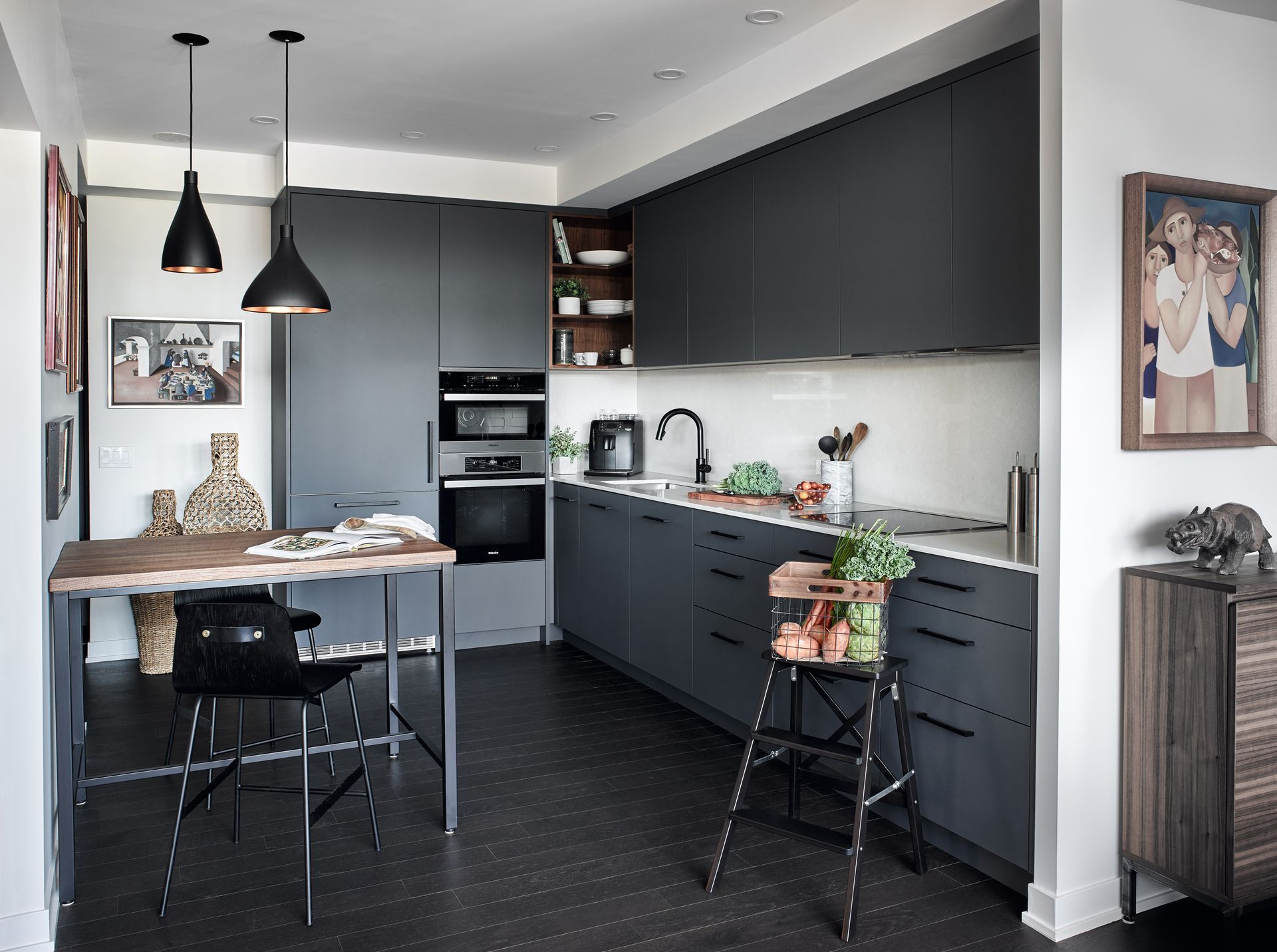 A kitchen with a table and chairs and a picture on the wall