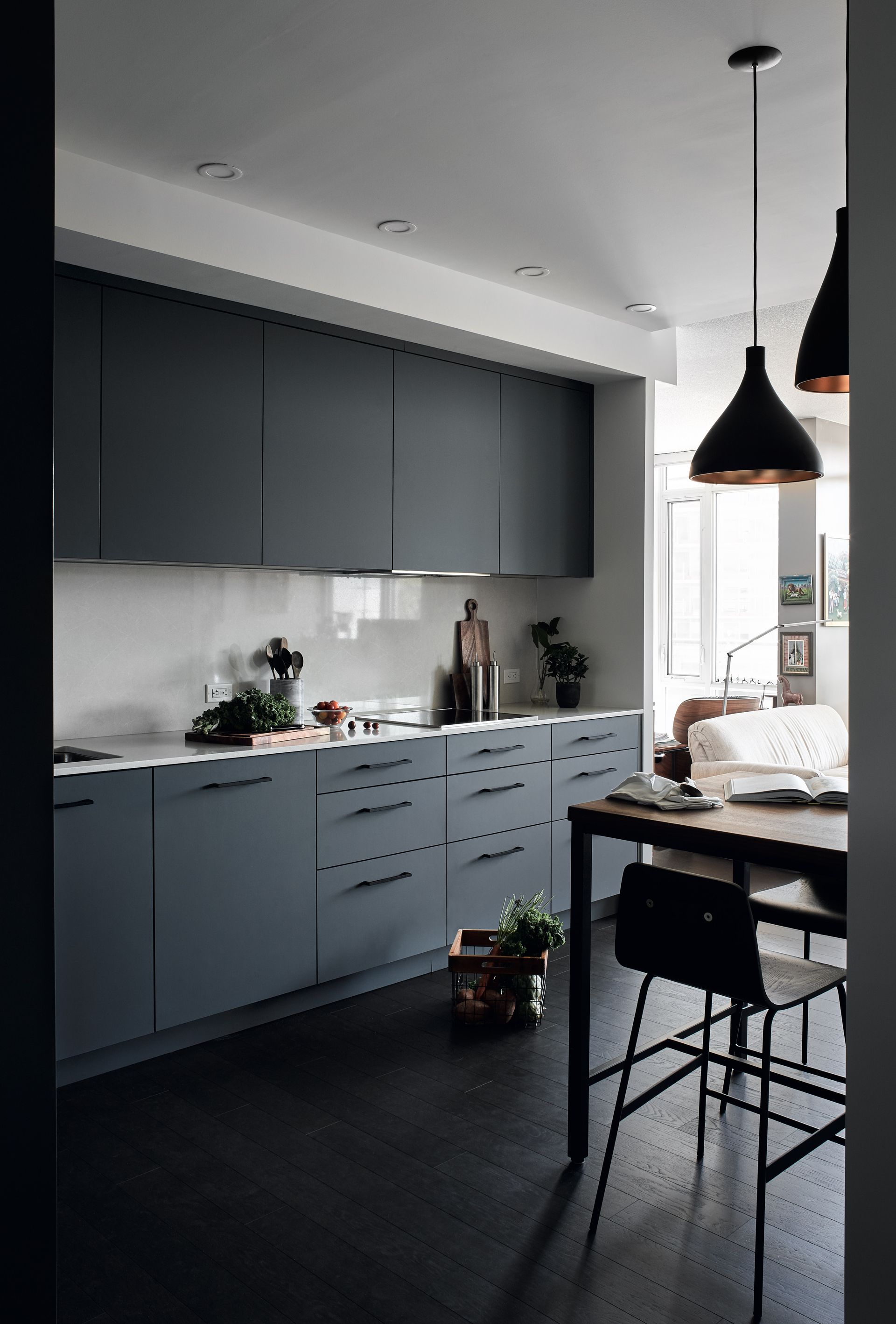 A kitchen with a table and chairs in it