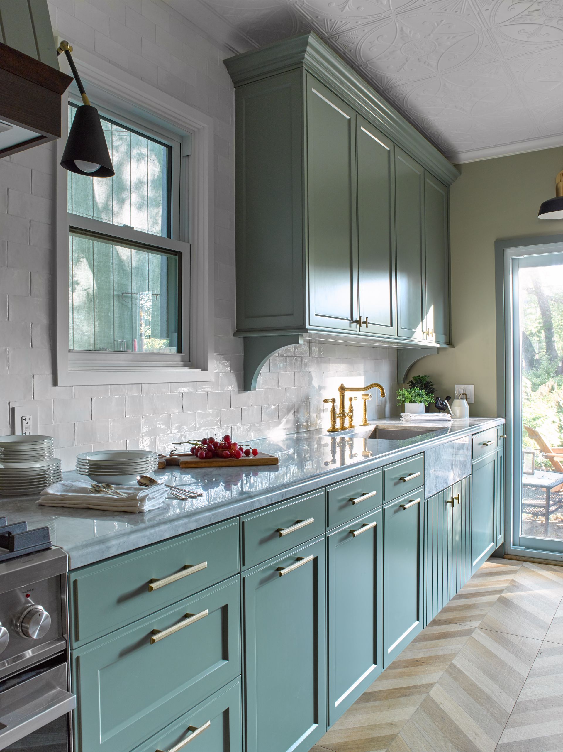 A kitchen with blue cabinets and white counter tops