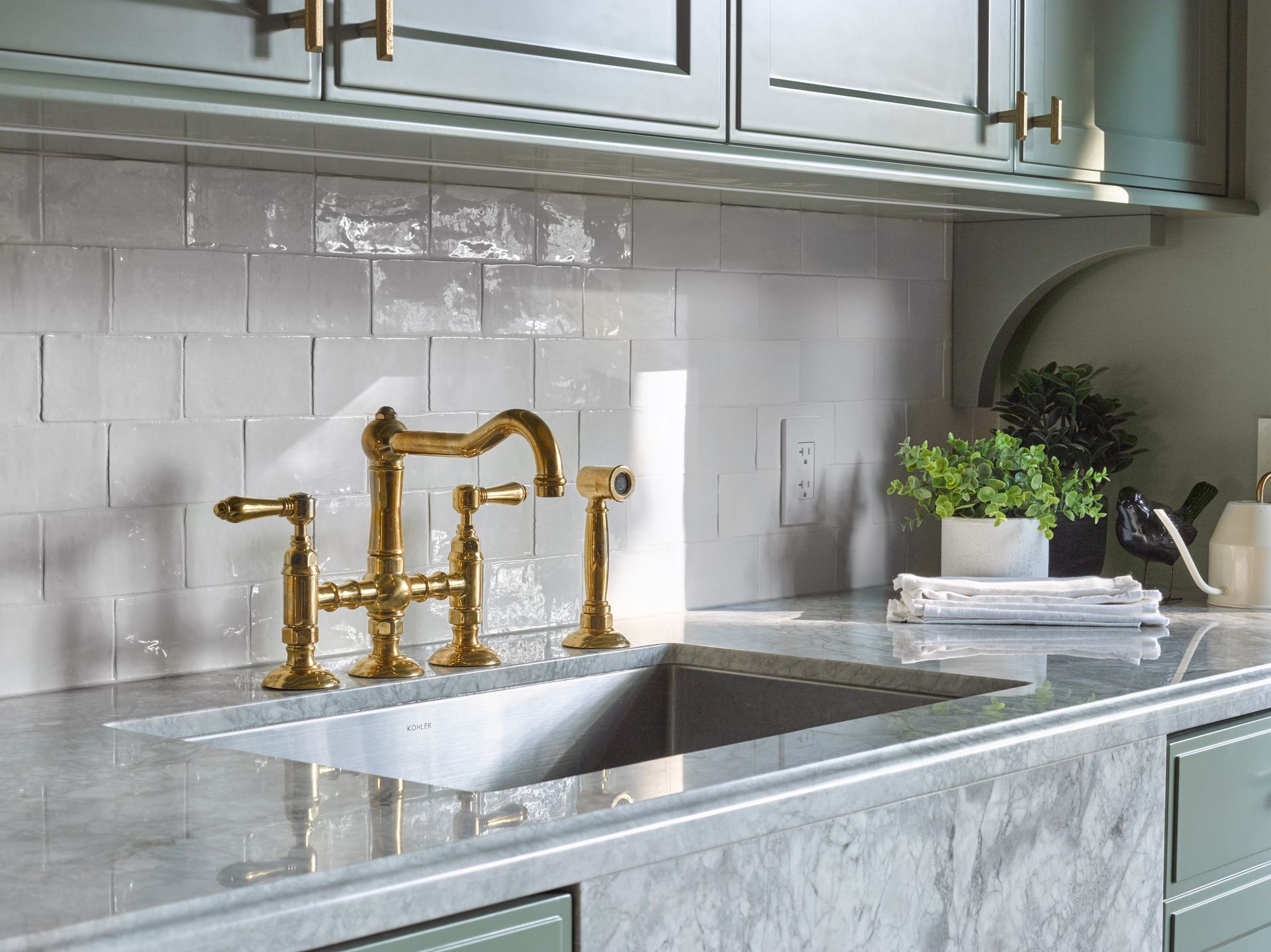 A kitchen with a sink and a faucet on the counter.