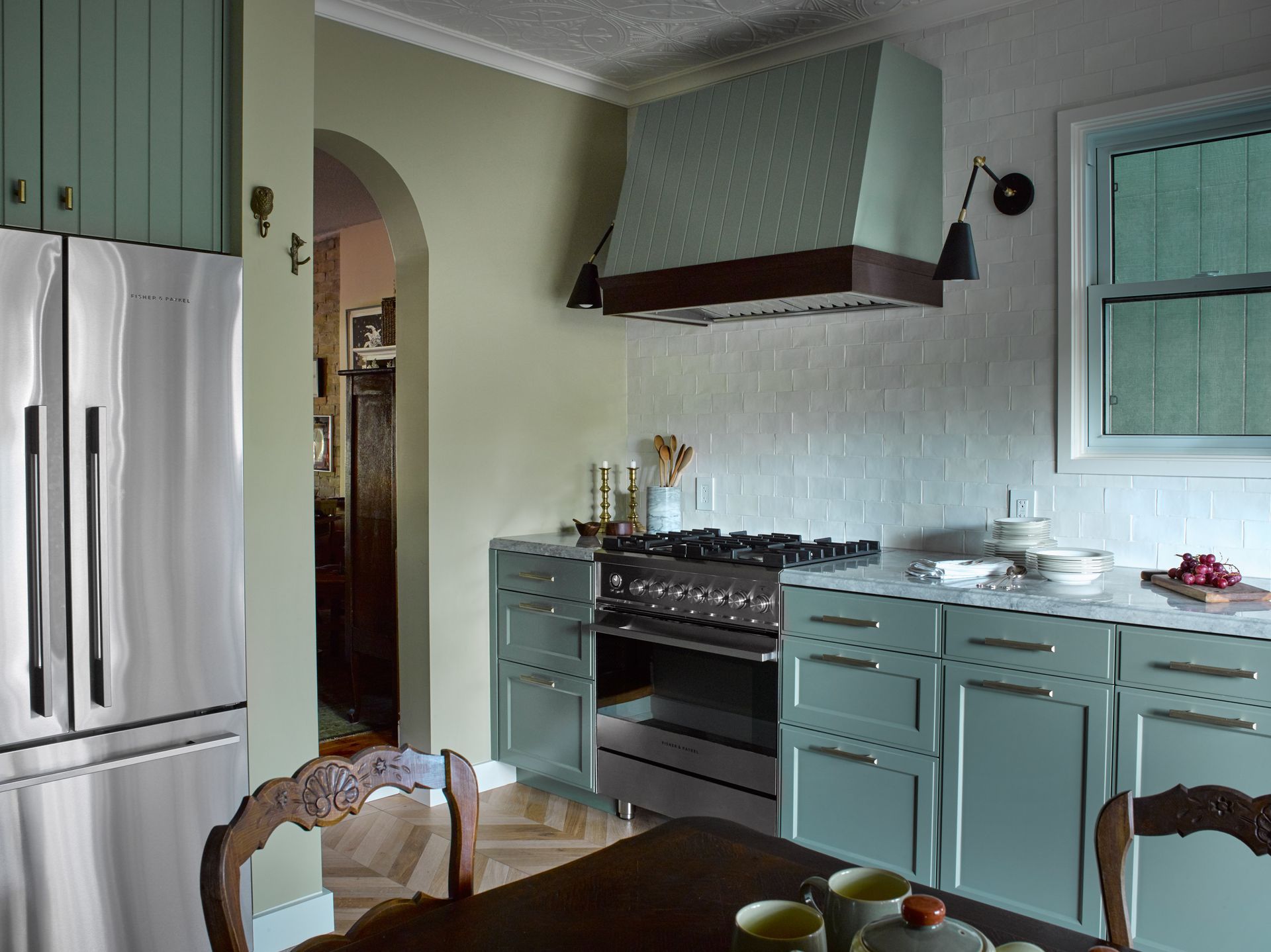 A kitchen with stainless steel appliances and blue cabinets
