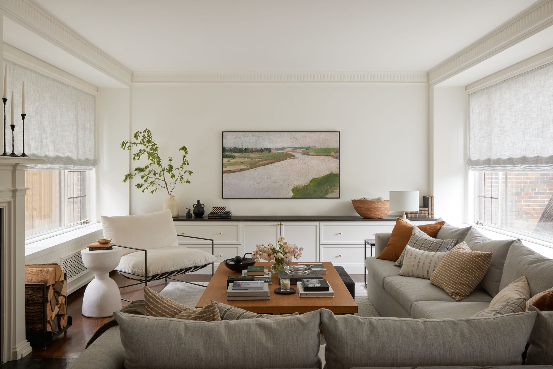 A living room with a couch , chair , table and television