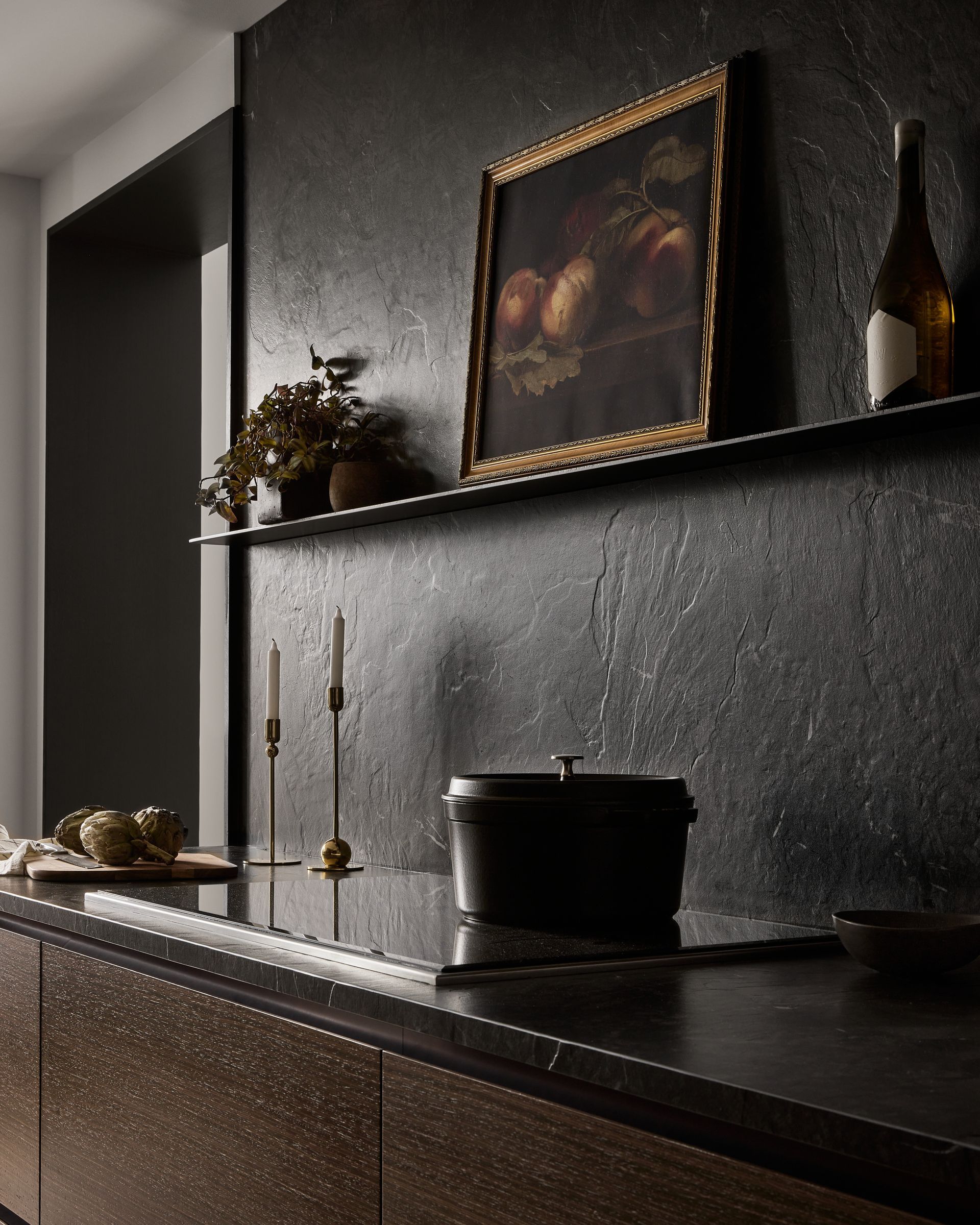 A kitchen with a picture on the wall above the stove
